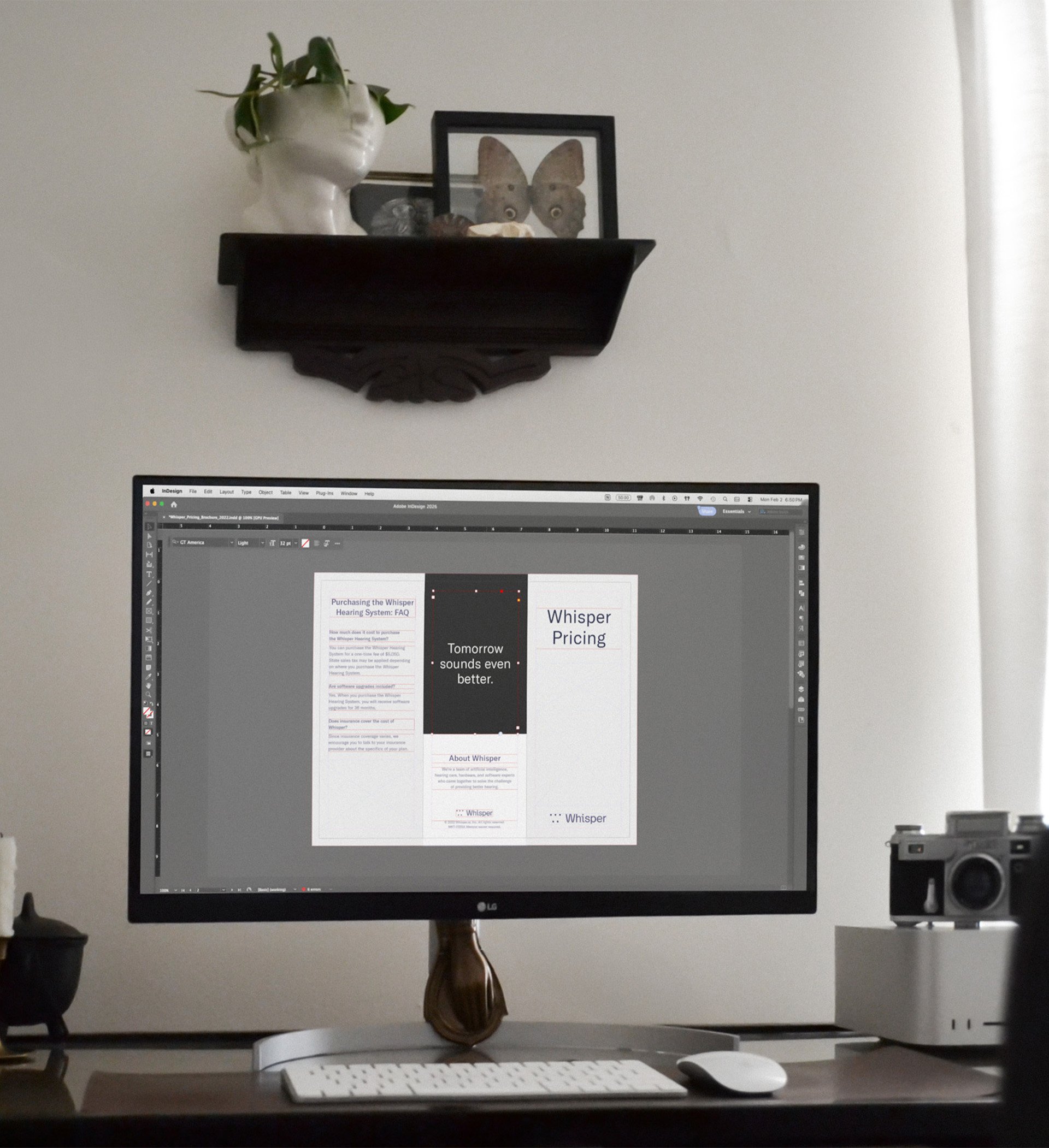 Desktop computer showing a brochure design in progress.