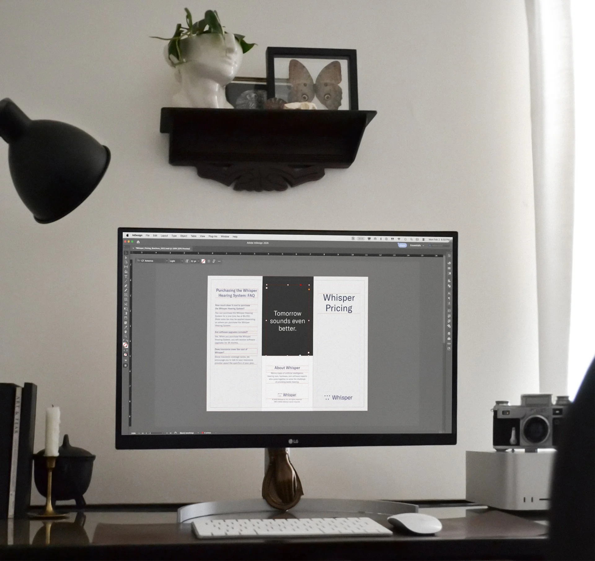 Desktop computer showing a brochure design in progress.