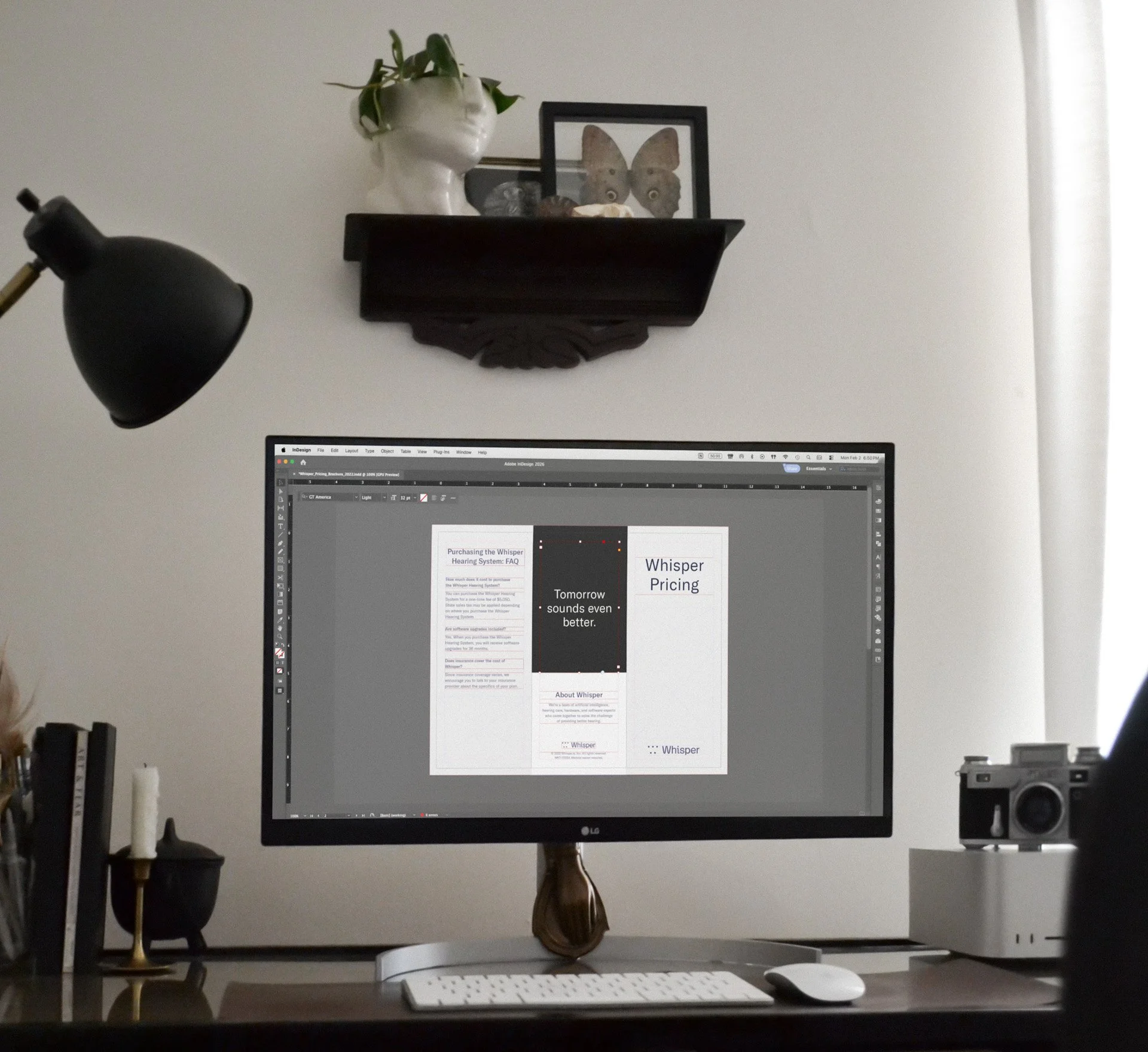 Desk with computer showing a design project in progress.