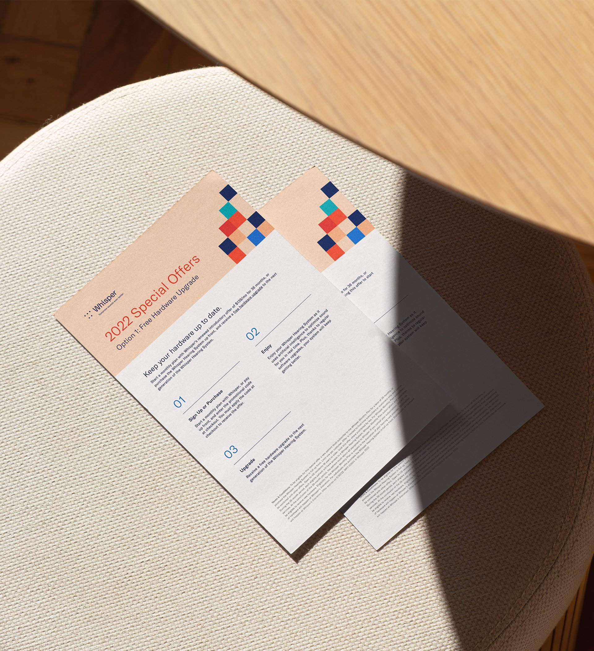 Flyers placed on a stool, promoting new pricing for a hearing aid brand.