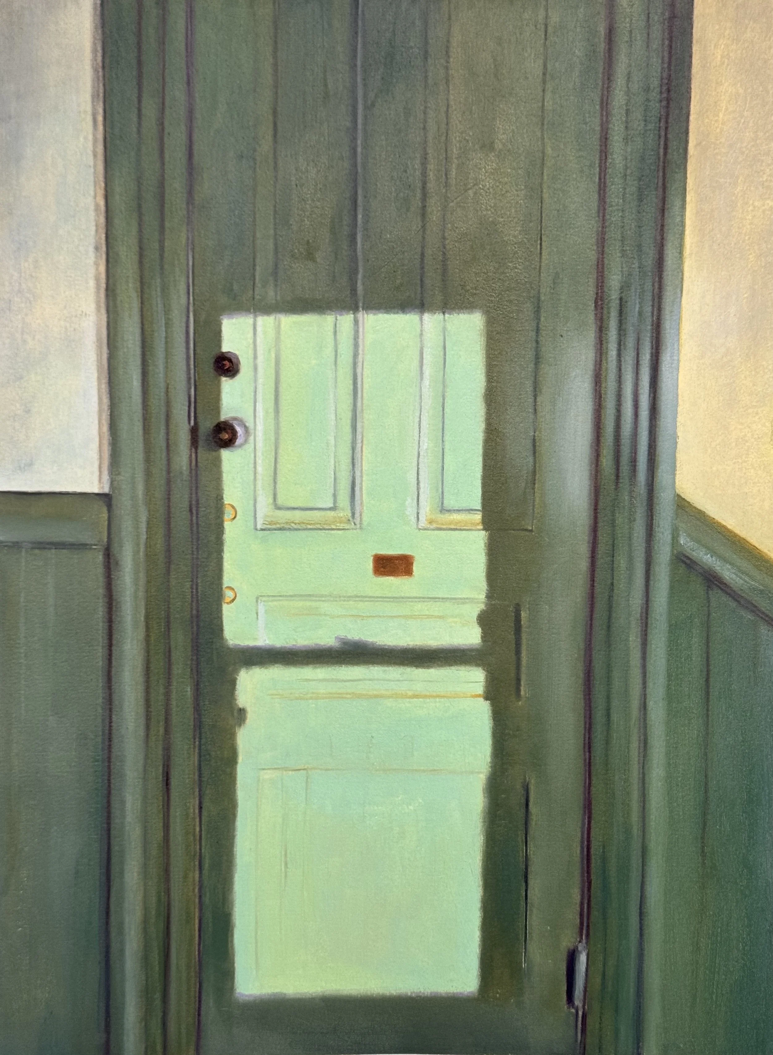 Sunlight brightens an area on a green door viewed straight ahead, several feet away.