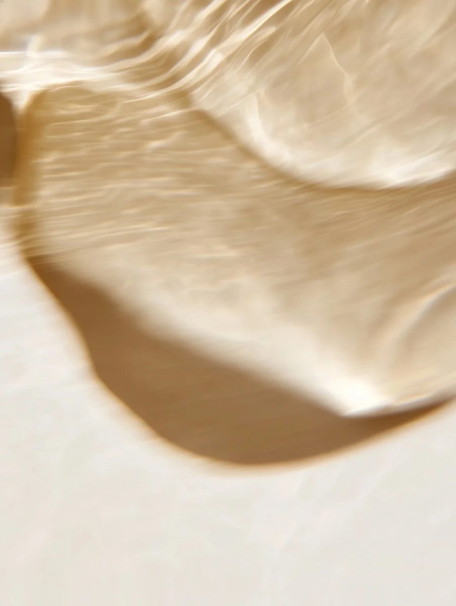 Close-up of a beige or light-colored fabric with folds and shadows