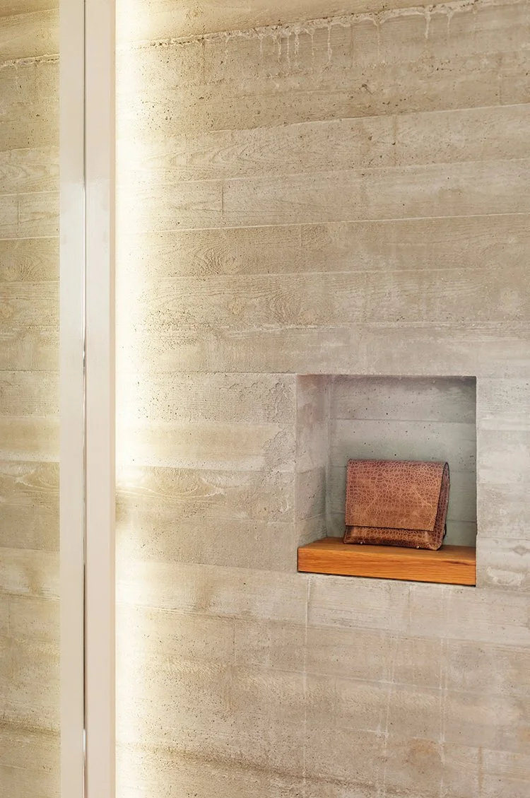 Rachel Comey retail store display with beige purse in wall nook made of concrete