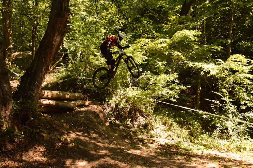biker flying in forest