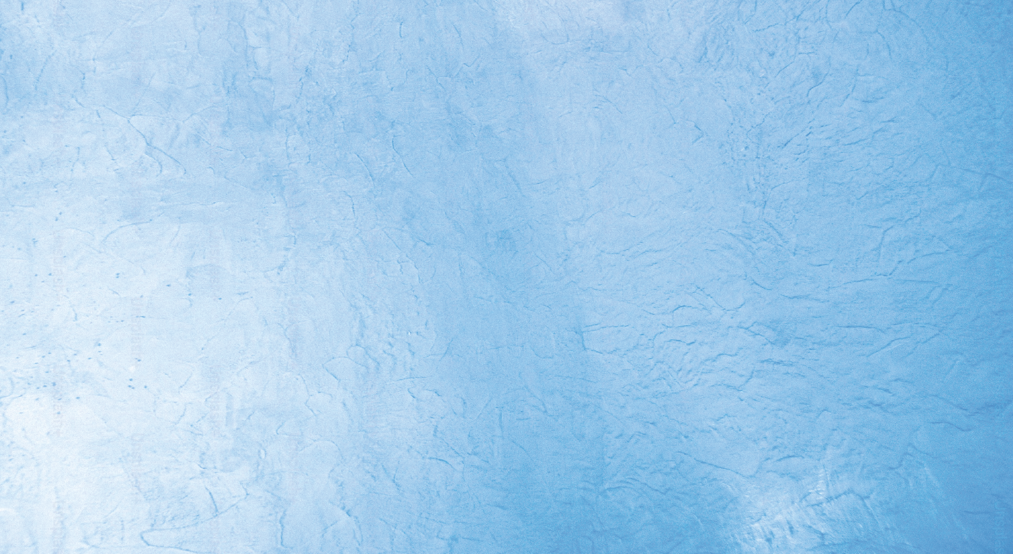 A blue textured wall with a rough, uneven surface.