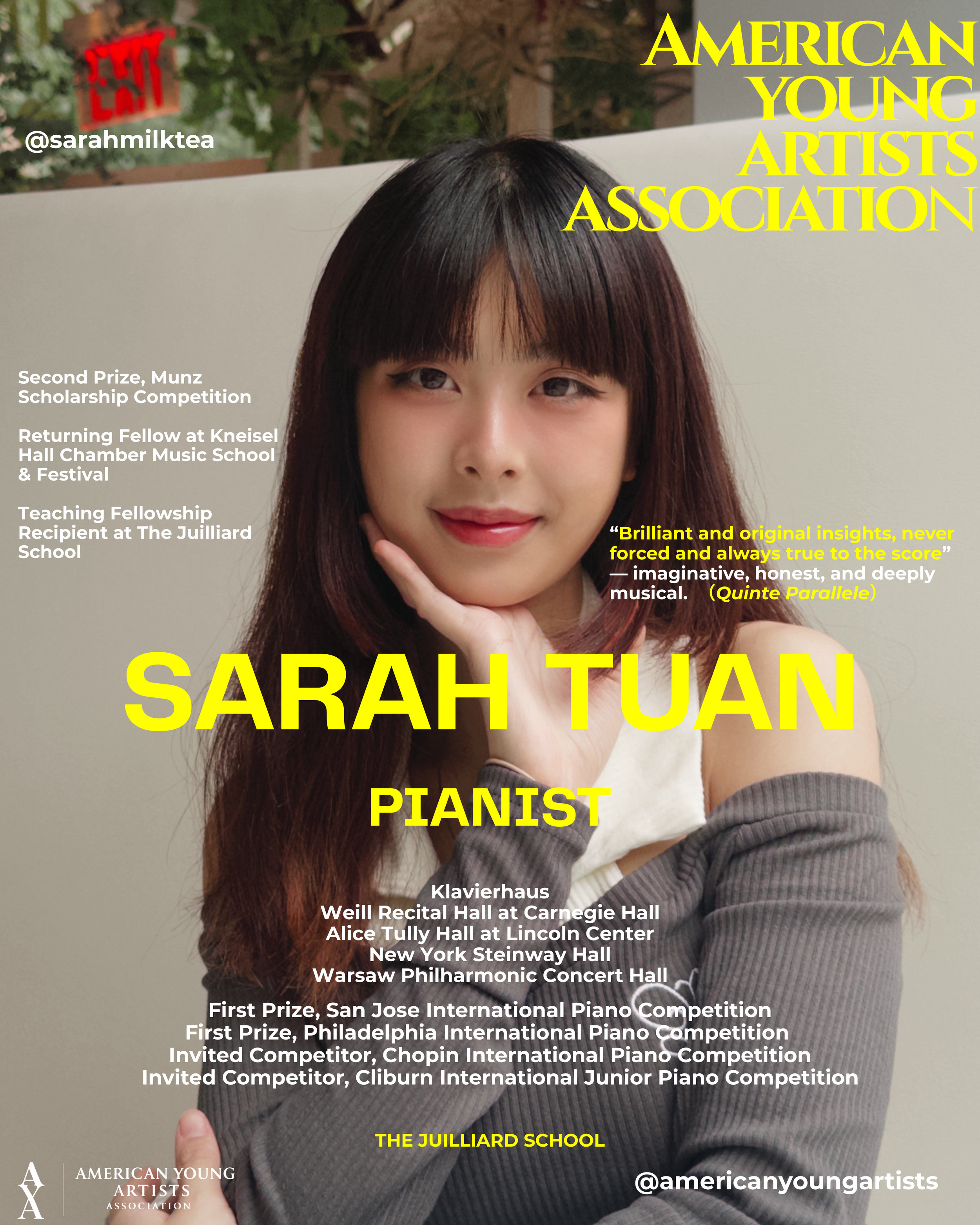 A young woman with long, dark hair and bangs, smiling softly with her hand on her chin, indoors against a plain background.