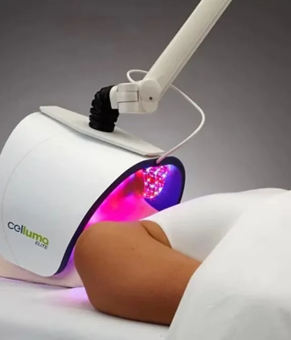 A person receiving laser treatment using a Celluma Lite LED therapy device.