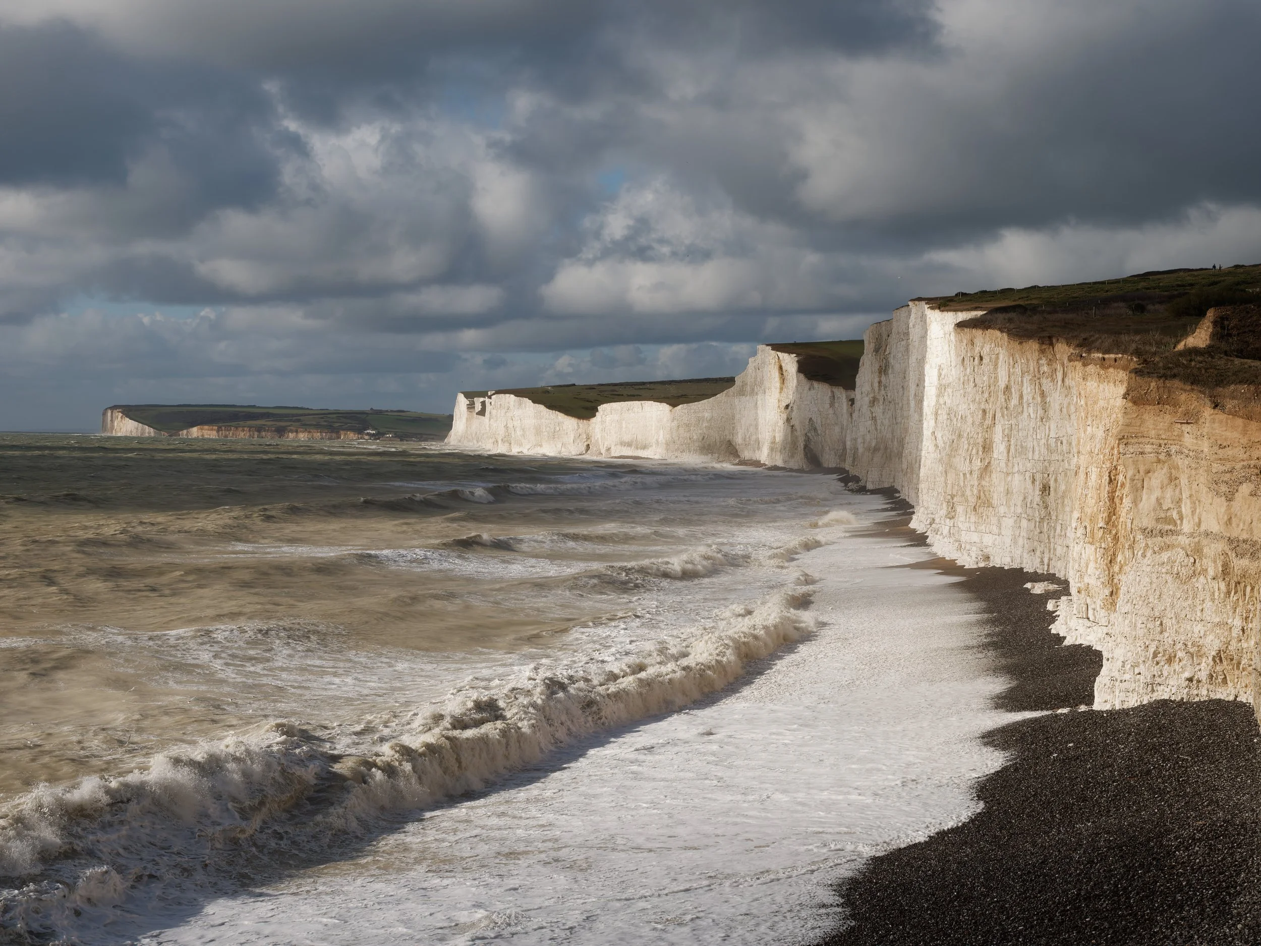 Stormy seas below the white chalk cliffs at Birling Gap, East Sussex.