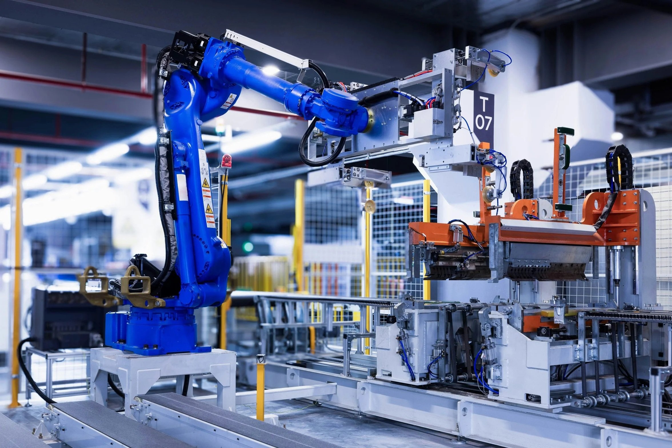 Automated robotic systems operating in a high-tech manufacturing environment, symbolizing continuous improvement and operational optimization