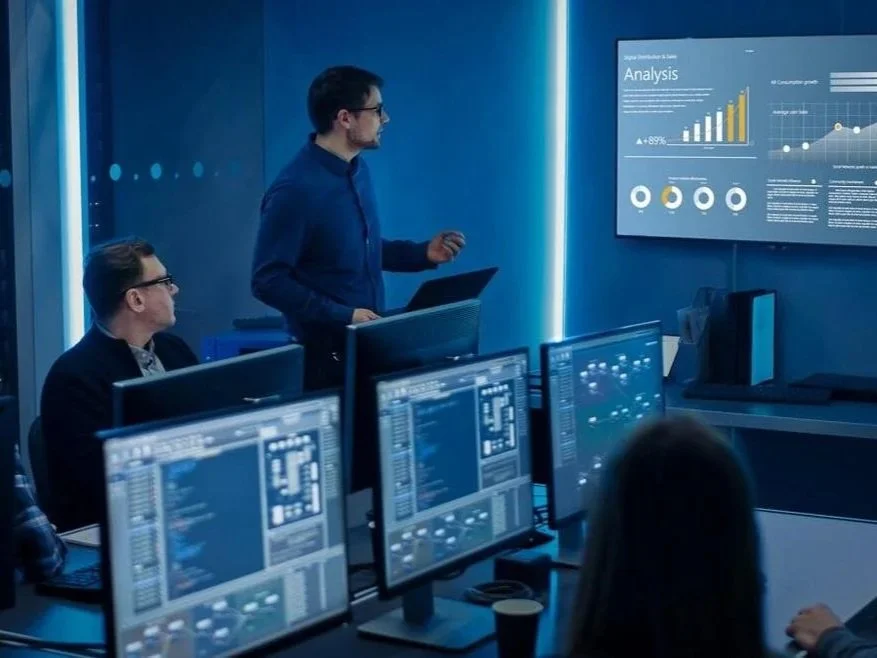 Consultants analyzing KPI dashboards and performance metrics to benchmark automotive shop efficiency