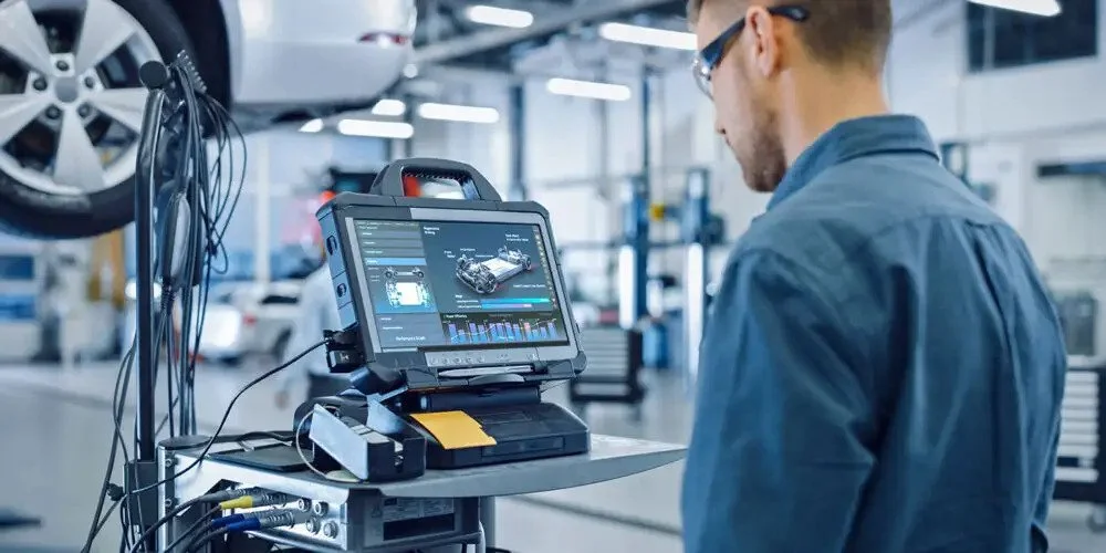 Collision consultant analyzing repair data and workflow metrics, upkeeping data-driven performance and operational excellence