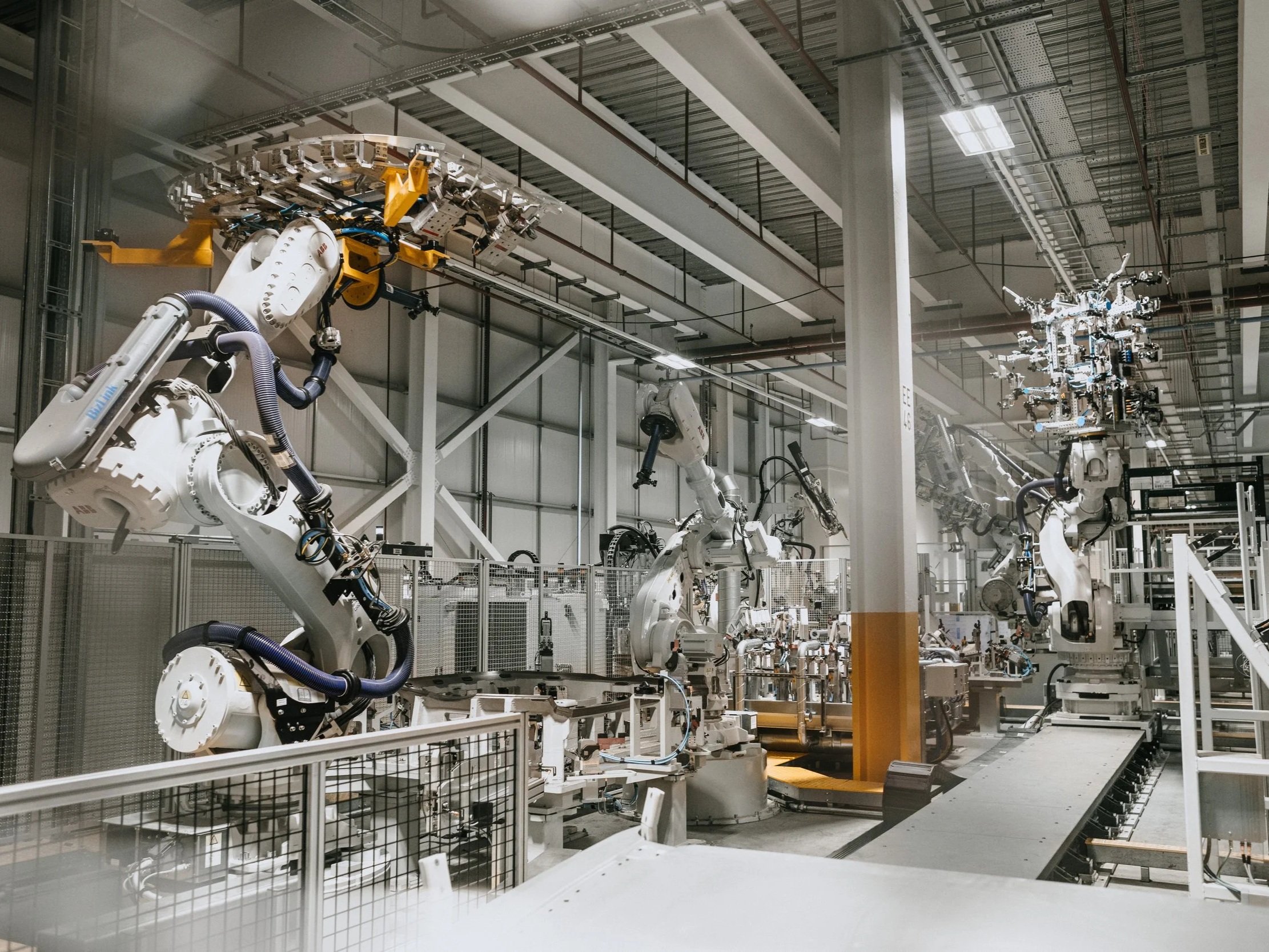 Automated manufacturing robots operating on a production line, representing lean implementation and process efficiency in modern facilities