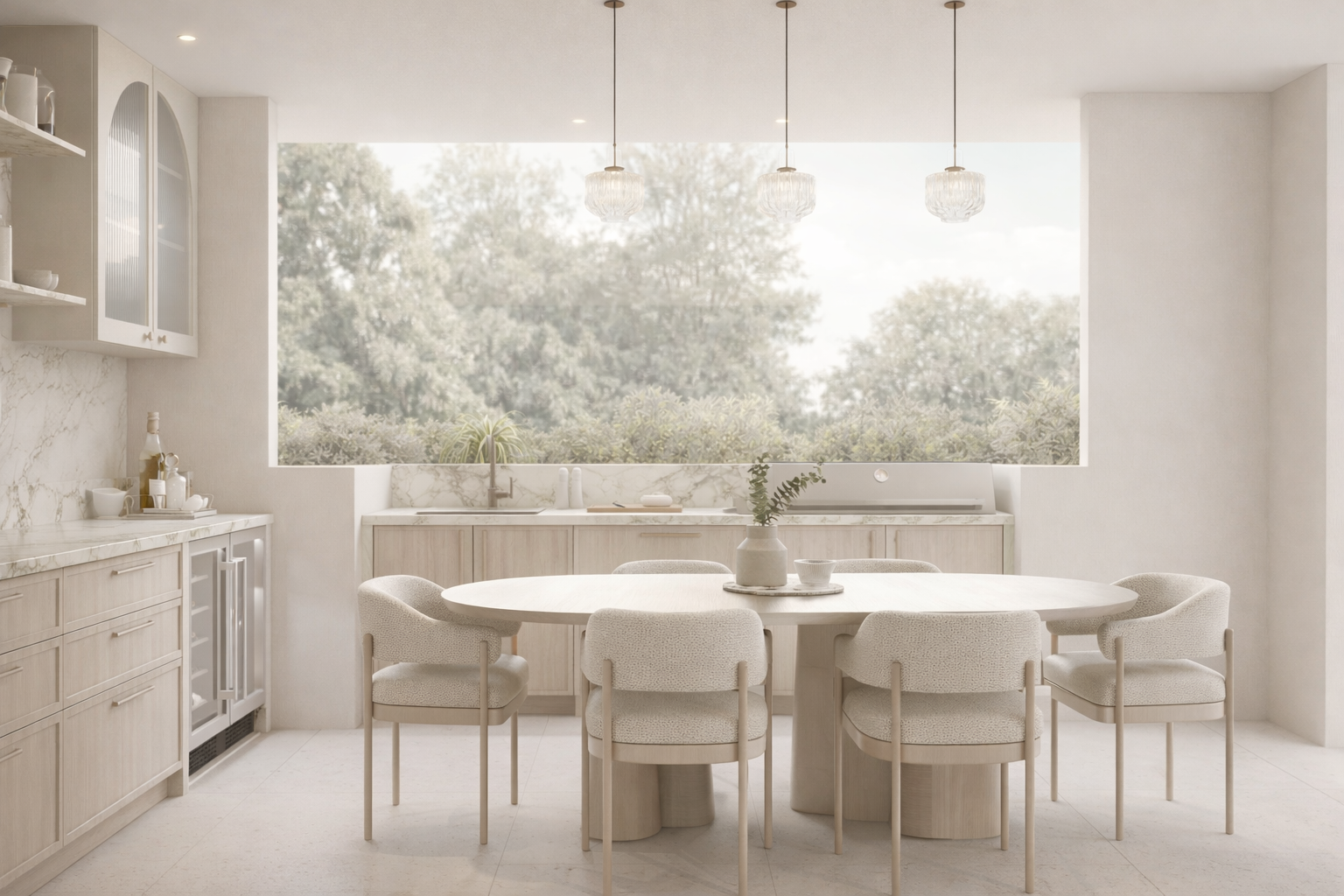 Modern kitchen with light wood cabinetry, marble counters, and a large window revealing lush greenery. A round dining table with six chairs sits below elegant pendant lights, creating a serene, airy feel.