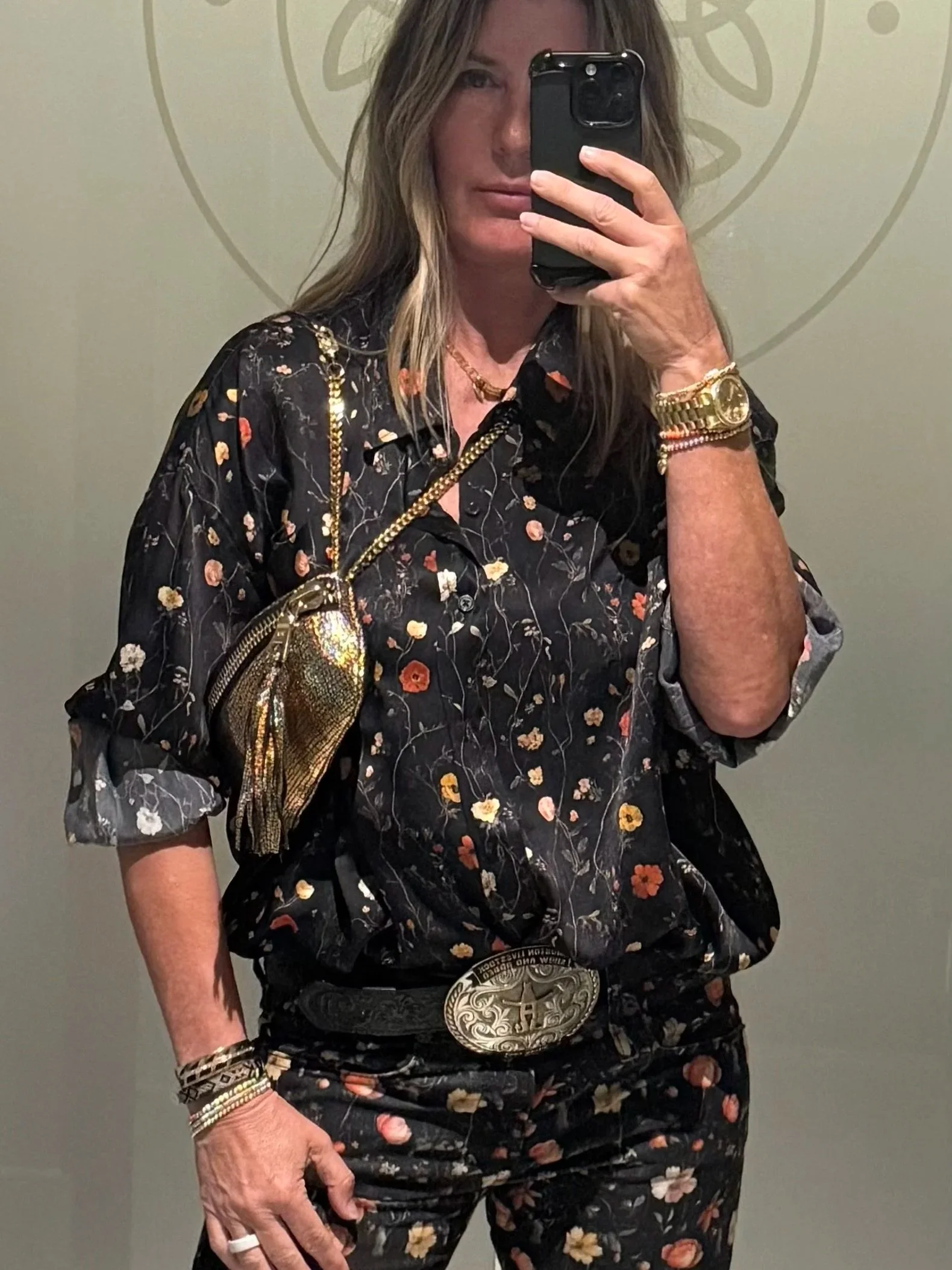 Metallic gold leather shoulder bag with a chain strap styled by Diane Izzedin.