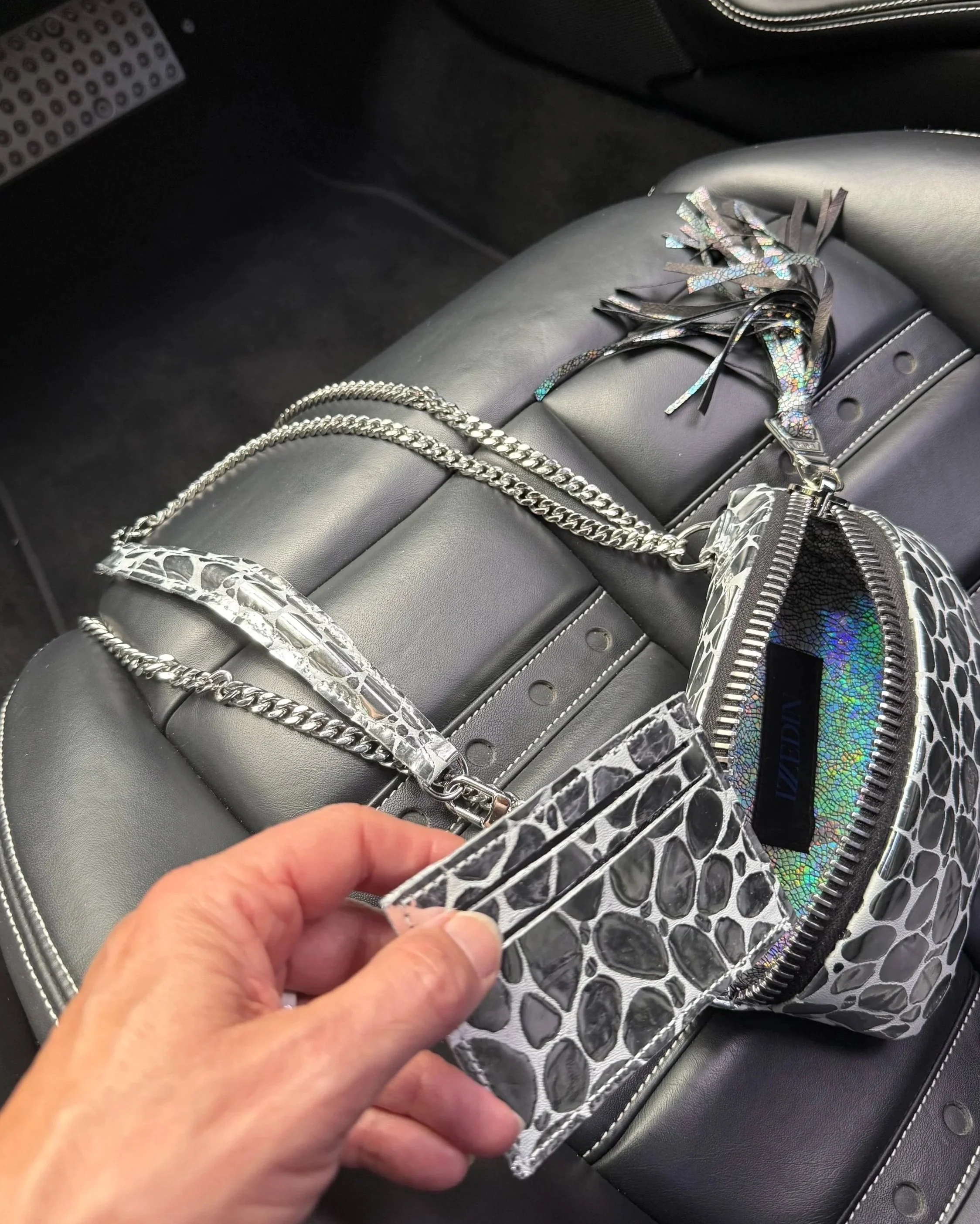 Silver metallic leather handbag featuring a removable zippered wallet and a detachable chain strap.