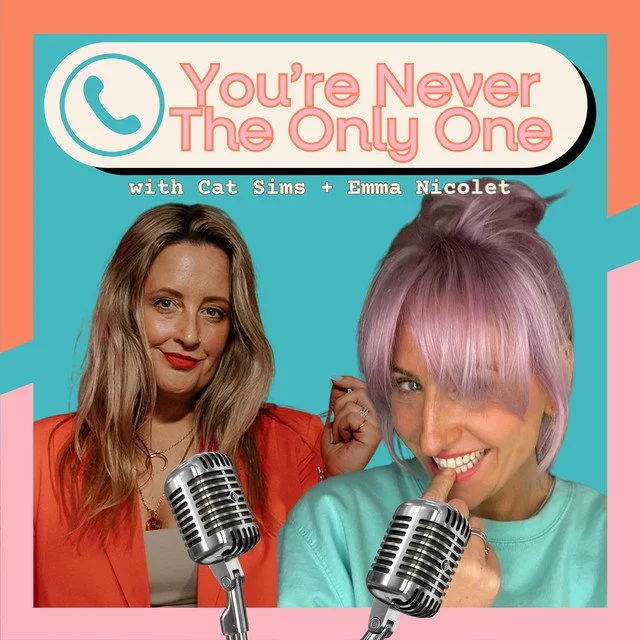 Podcast cover art for "You're Never The Only One" featuring Cat Sims and Emma Nicolet, showing two women, one with long blonde hair and red lipstick and the other with pastel purple hair, smiling with vintage microphones against a colorful background