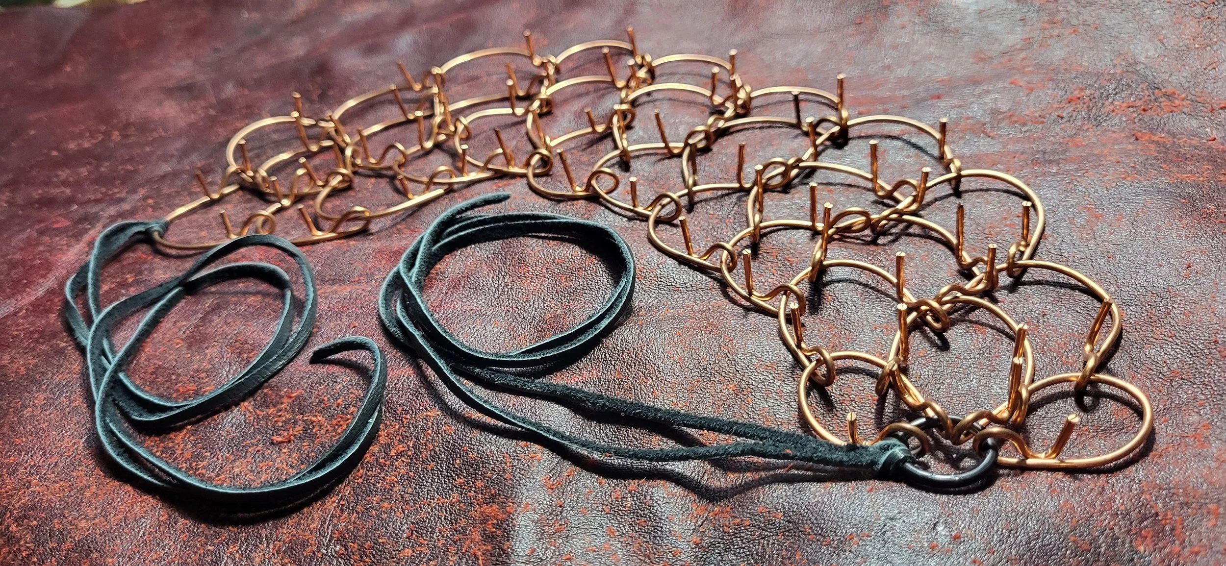 A metal necklace with leather strap ties.