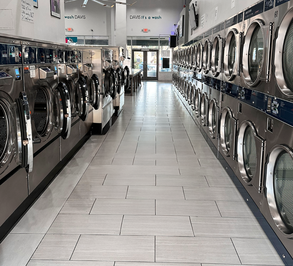 A clean laundry mat in Davis California with multiple washing machines on both sides, in Davis California, at Davis Laundry clean laundromat