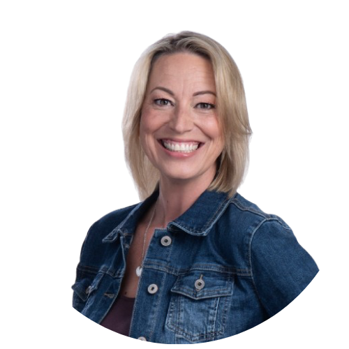A woman with blonde hair smiling, wearing a denim jacket.