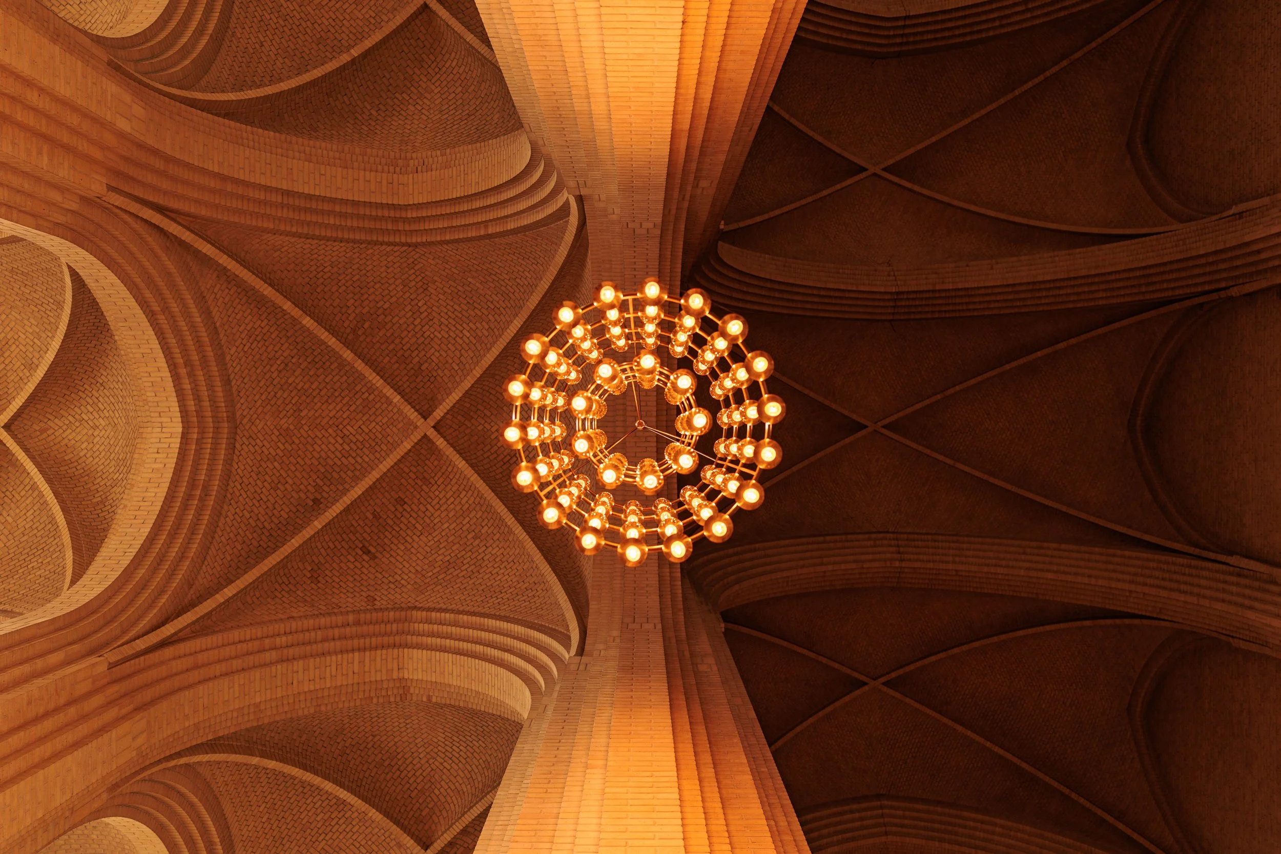 Looking up at a chandelier hanging from a ceiling with curved, brick patterns and architectural details.