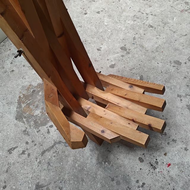 Sculptural hand shaped slatted chair 5.png
