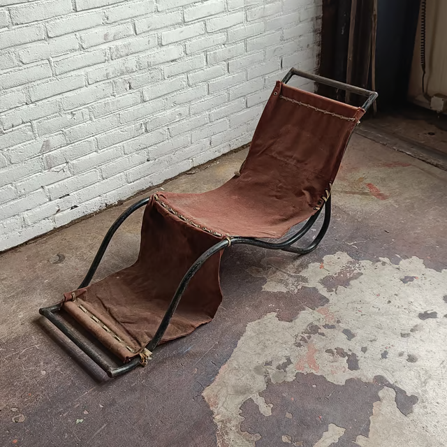 Low tubular and canvas lounge chair