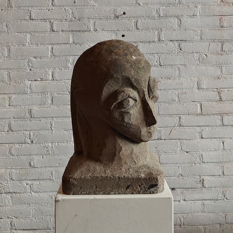 Concrete sculpture, stylized head