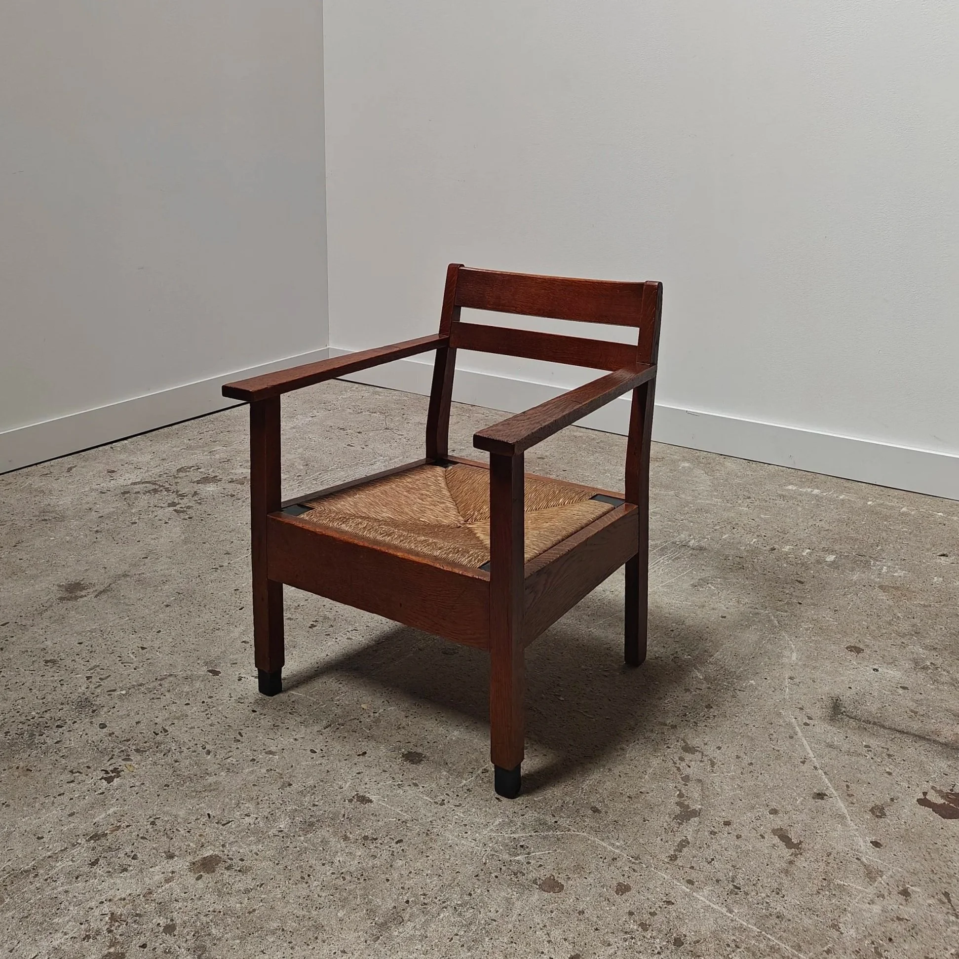 Haagse school armchair with rush seats and black accents