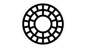 A black and white circular object resembling a wheel or a dial with a central hole and a pattern of rectangles around it.