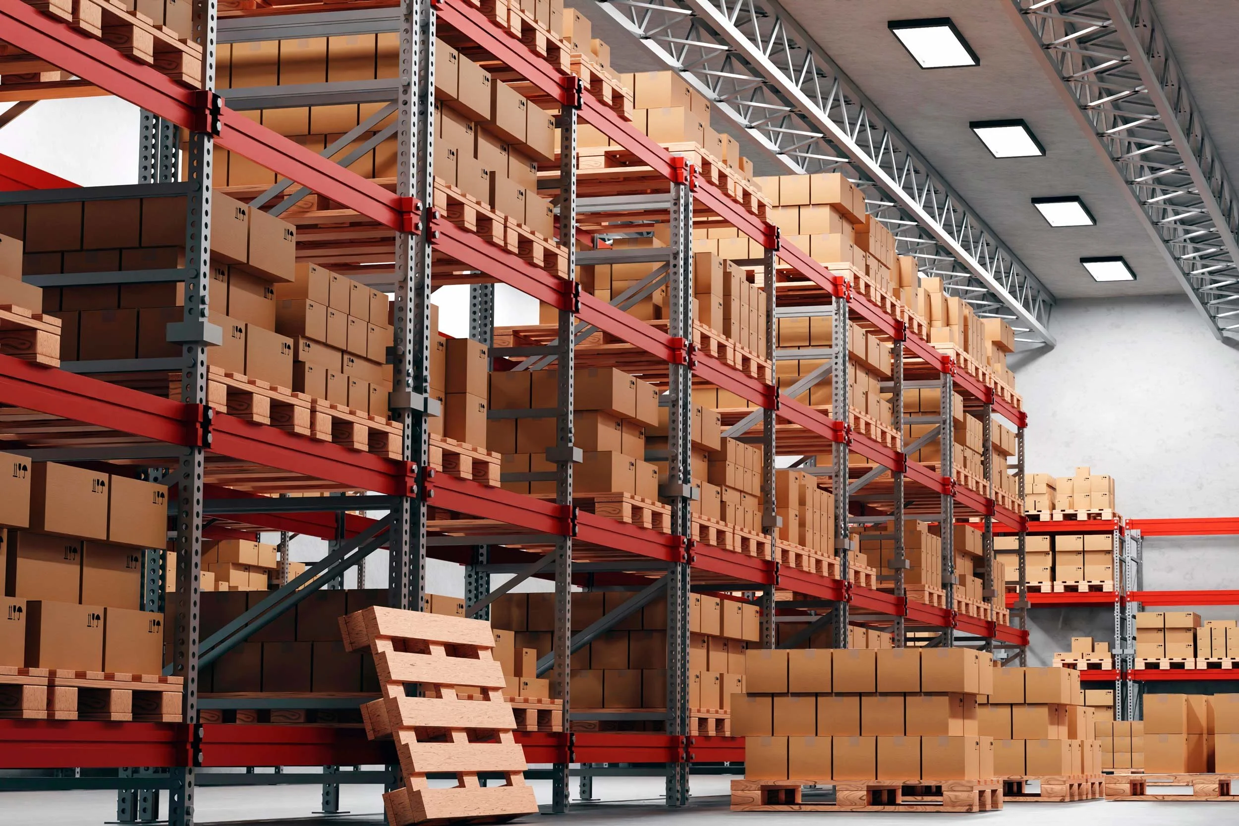 Interior of a warehouse with tall shelving units loaded with cardboard boxes and wooden pallets, and a small wooden pallet leaning against the shelves.