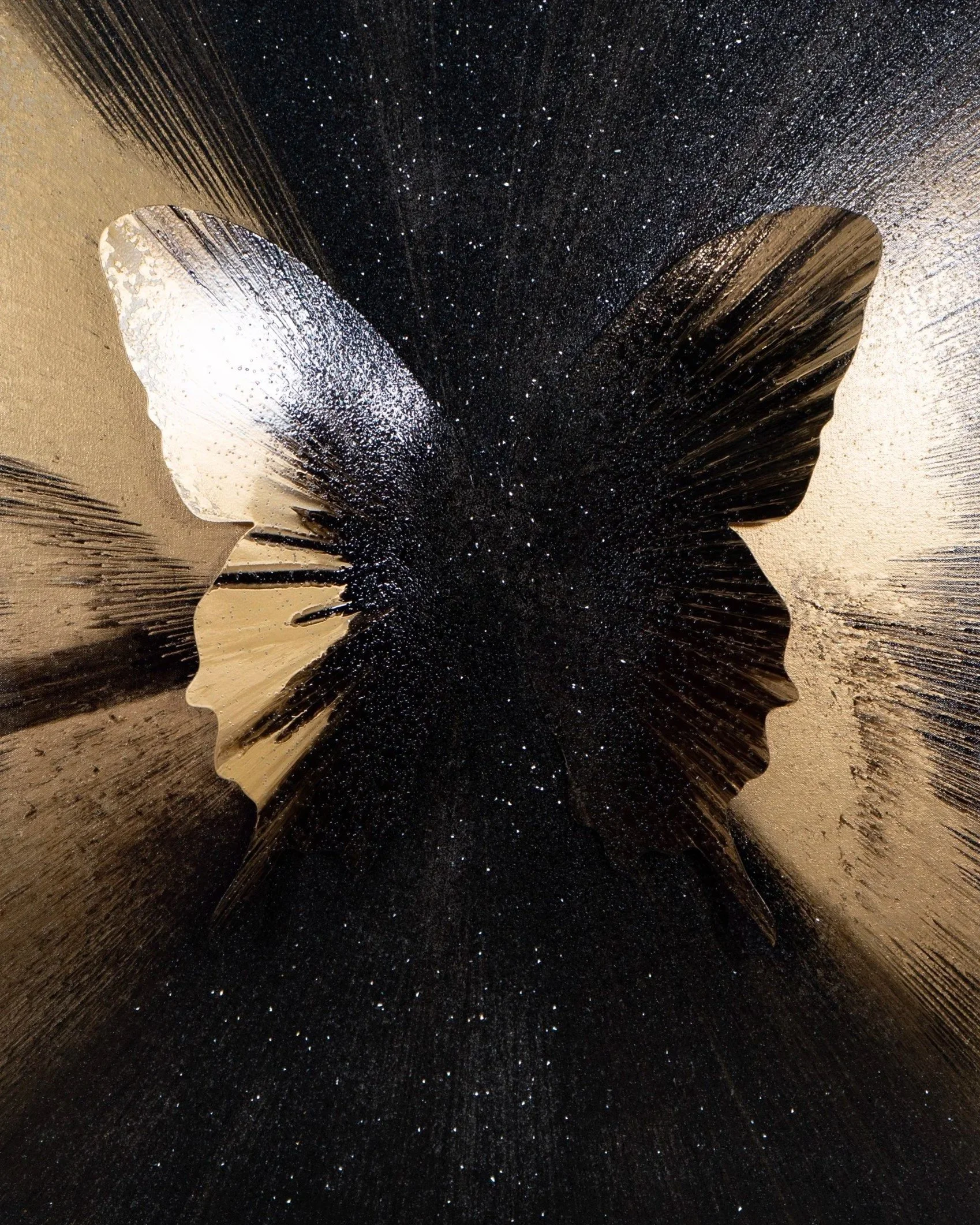 A butterfly-shaped mirror with a black background, reflecting a woman’s silhouette in profile.