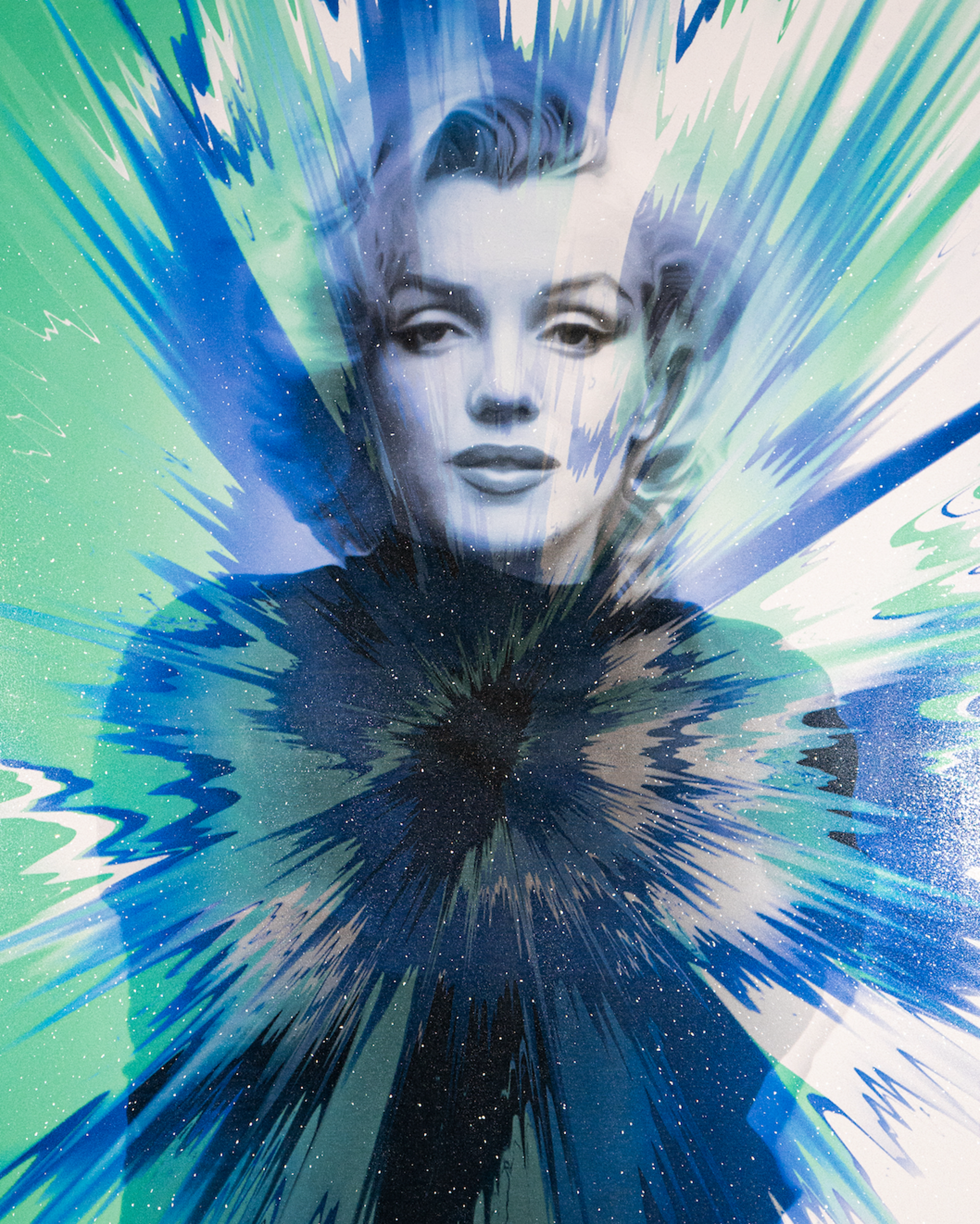 Portrait of a woman with styled hair and makeup, surrounded by vibrant blue, green, and white light streaks and splashes.