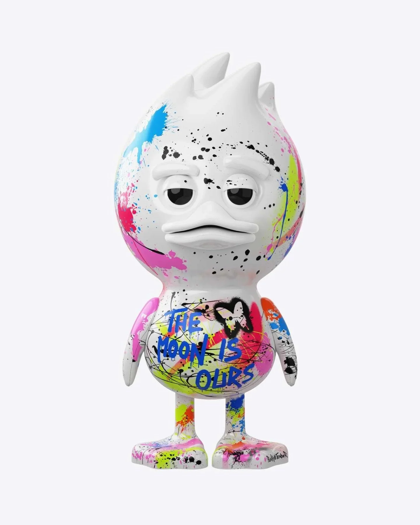 A colorful, graffiti-style art sculpture of a cartoonish bird with a large head, droopy eyes, and a beak, painted with splashes of pink, blue, yellow, and black. The body has the phrase 'THE MOON IS OURS' written in blue, along with a heart and various abstract designs.