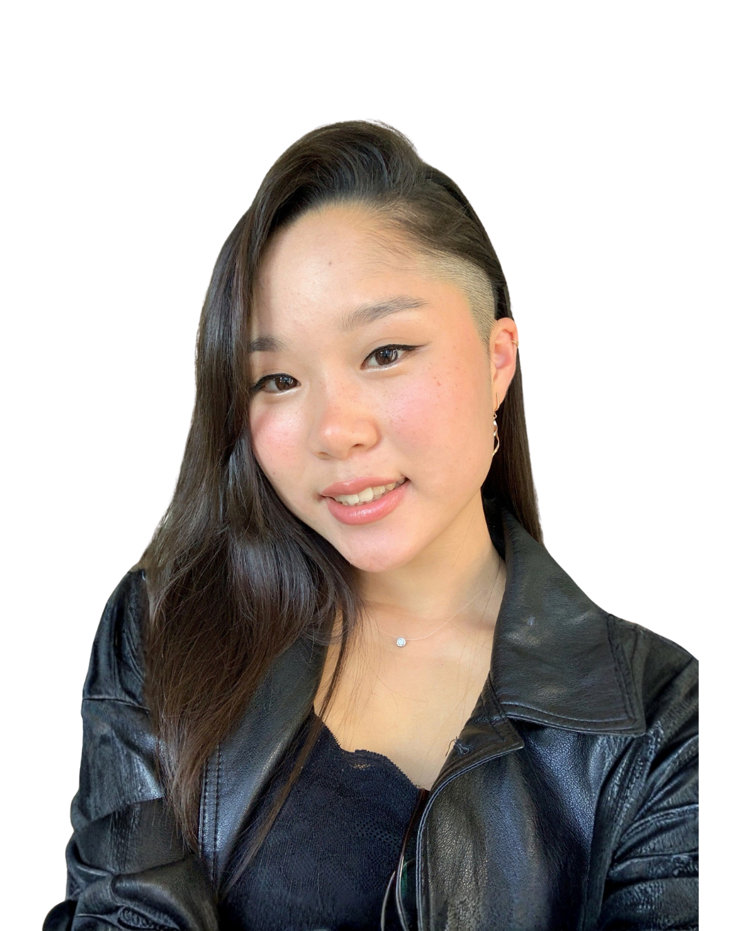 Young woman with long dark hair and a side shaved hairstyle, wearing a black leather jacket and a delicate necklace, smiling at the camera against a white background.