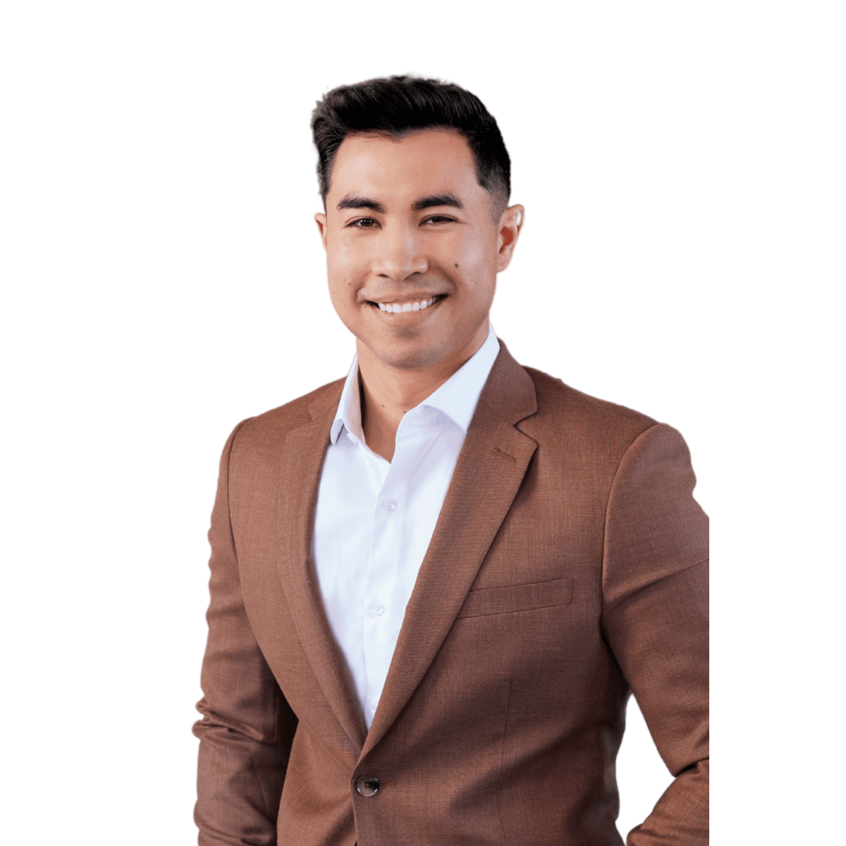 Young man with dark hair in a brown suit smiling at the camera against a white background.