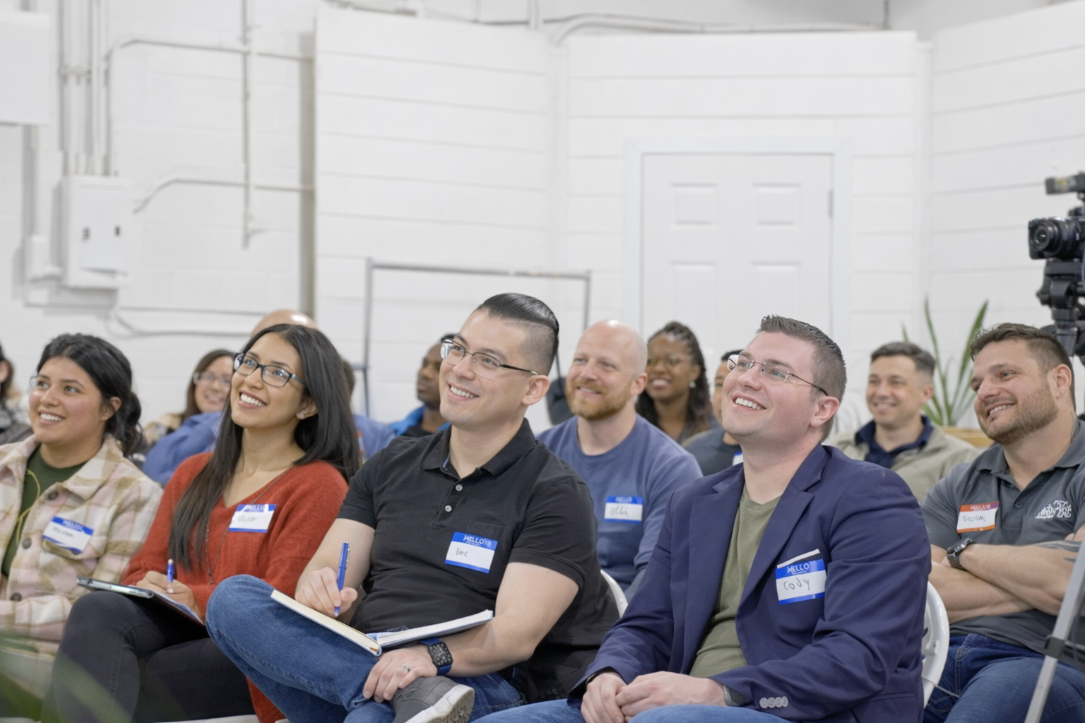 An engaged and smiling audience at a Mogul Mastermind event