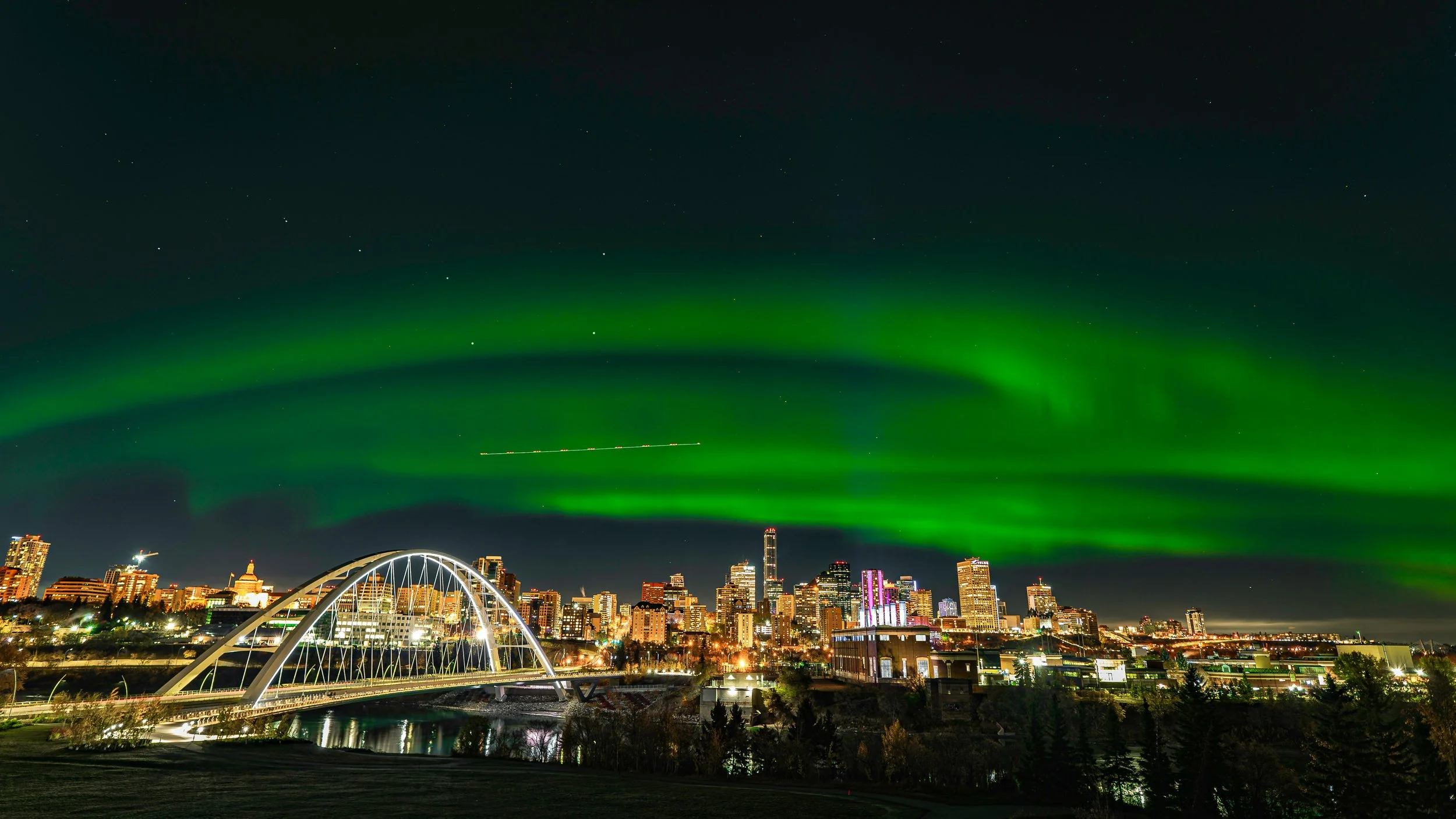 Green northern lights over Edmonton downtown
