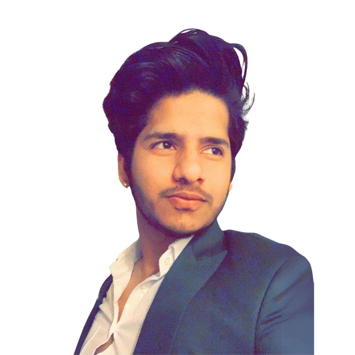 A young man with black hair styled upward, wearing a black blazer and white shirt, looking to the side with a neutral expression, against a plain white background.