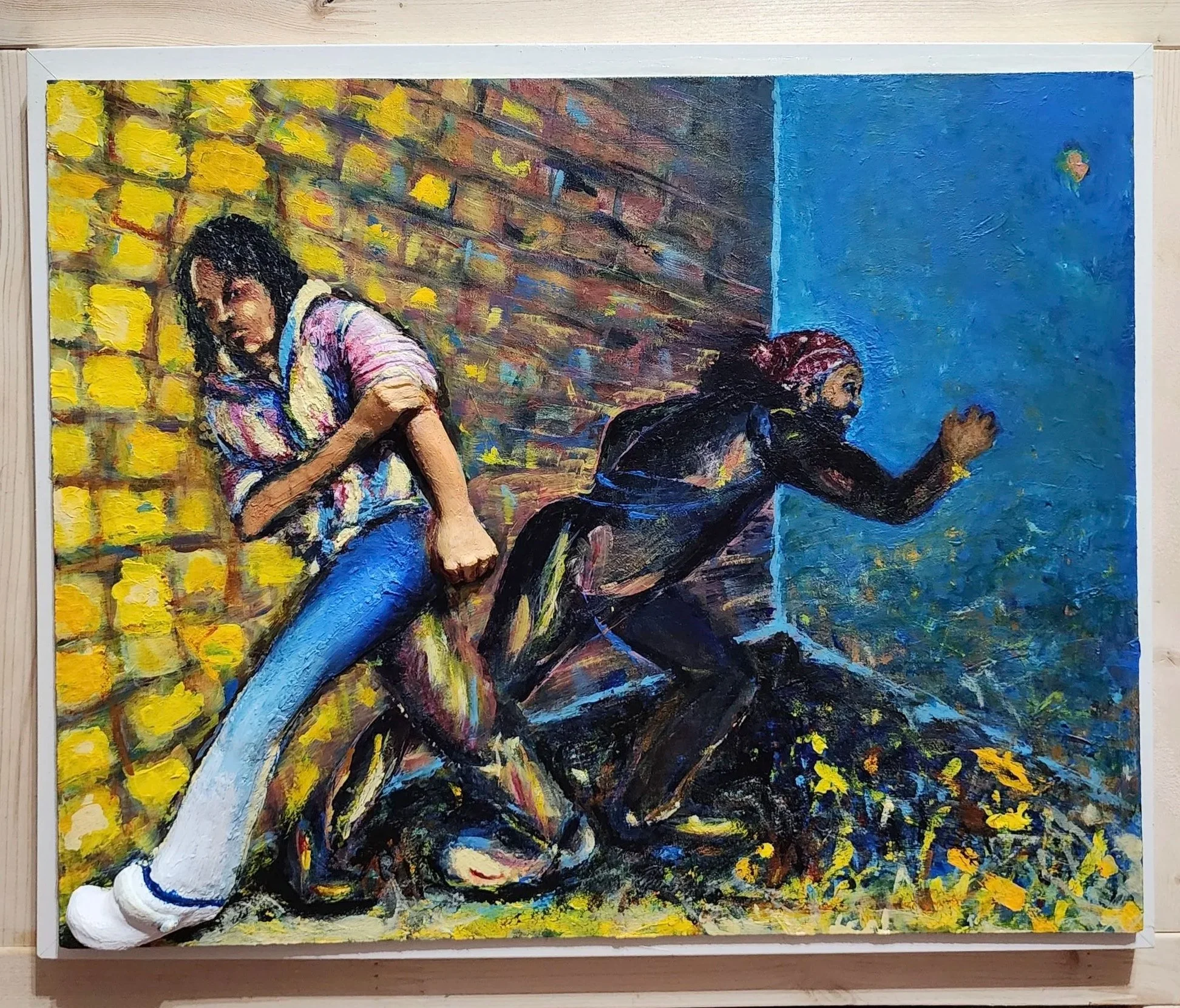A colorful painting depicting two women, one with dark hair wearing a striped top and jeans, leaning against a brick wall, and the other wearing a headscarf and working in a garden.
