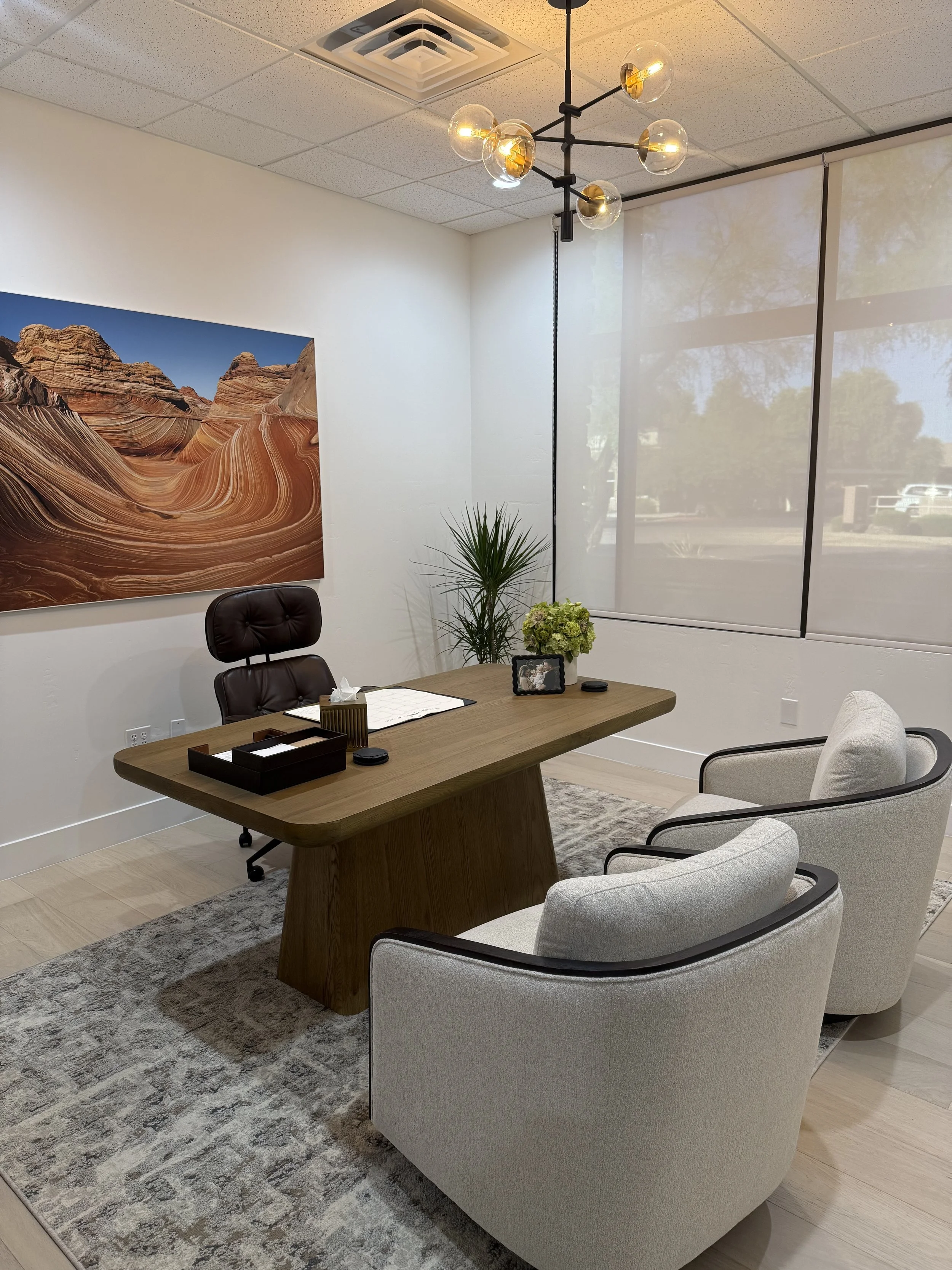 Renovated medical office in Phoenix, Arizona featuring modern reception area, warm finishes, upgraded exam rooms, and custom lighting — commercial build-out by Constructum.