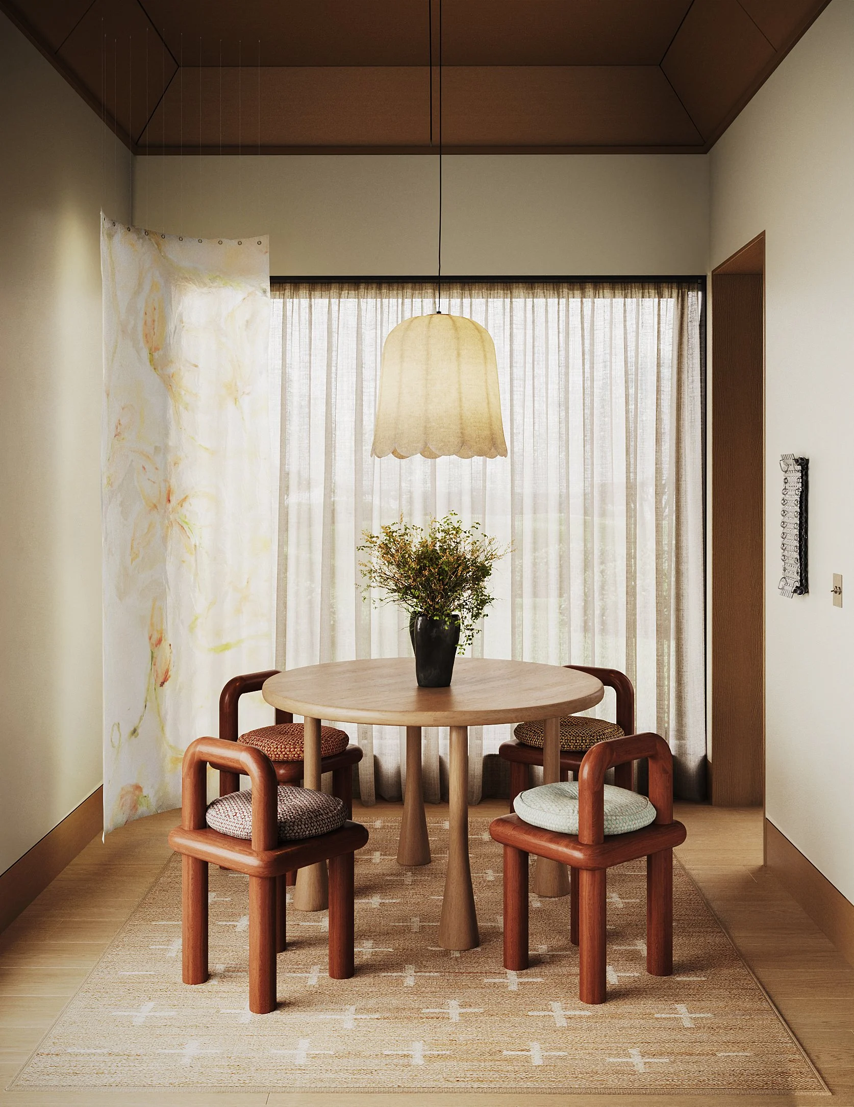 A cozy dining nook with a round wooden table, four wooden chairs with upholstered seats, a vase of flowers as a centerpiece, sheer curtains, and a hanging lampshade.