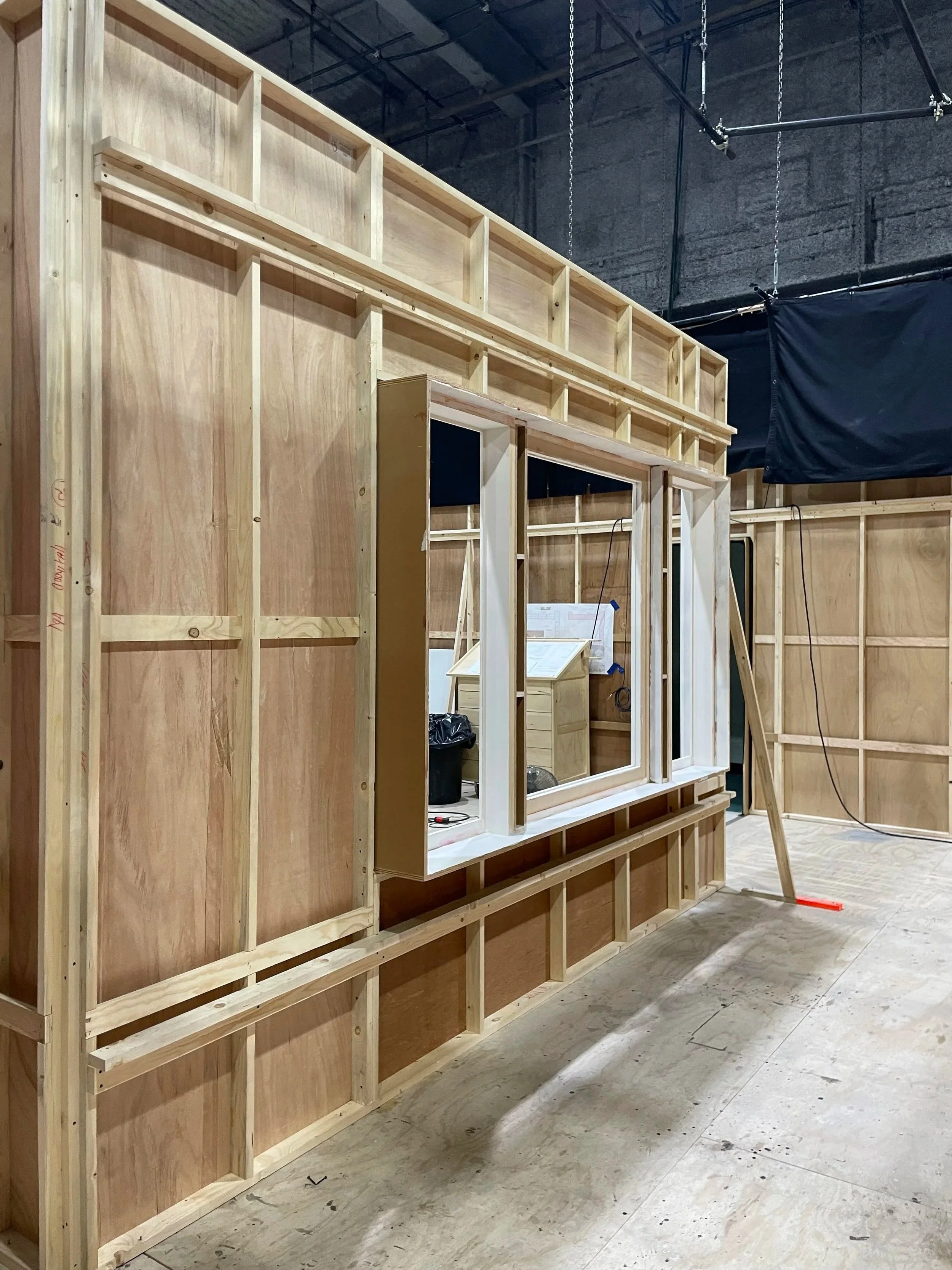Wooden framing and wall structure in a construction or studio set.