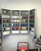 "Paint color-matching cabinets displaying hundreds of finish chips used to match custom RV paint schemes."