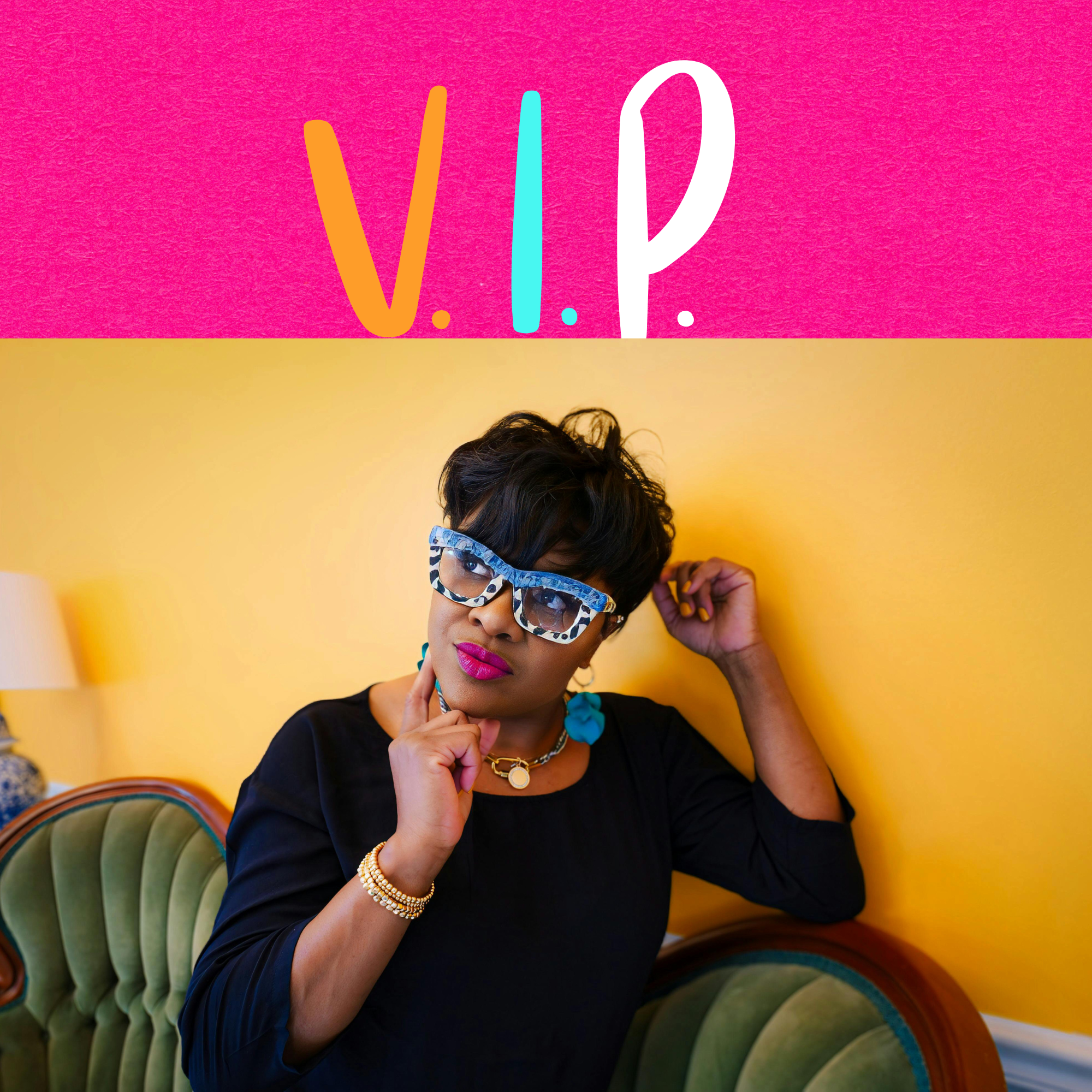 A woman with short dark hair and vibrant lipstick, wearing large patterned glasses, a black top, and colorful jewelry, sitting on a vintage green velvet sofa against a yellow wall, with a yellow lamp in the background. The top part of the image features a pink background with the text 'V.I.P.' in colorful letters.