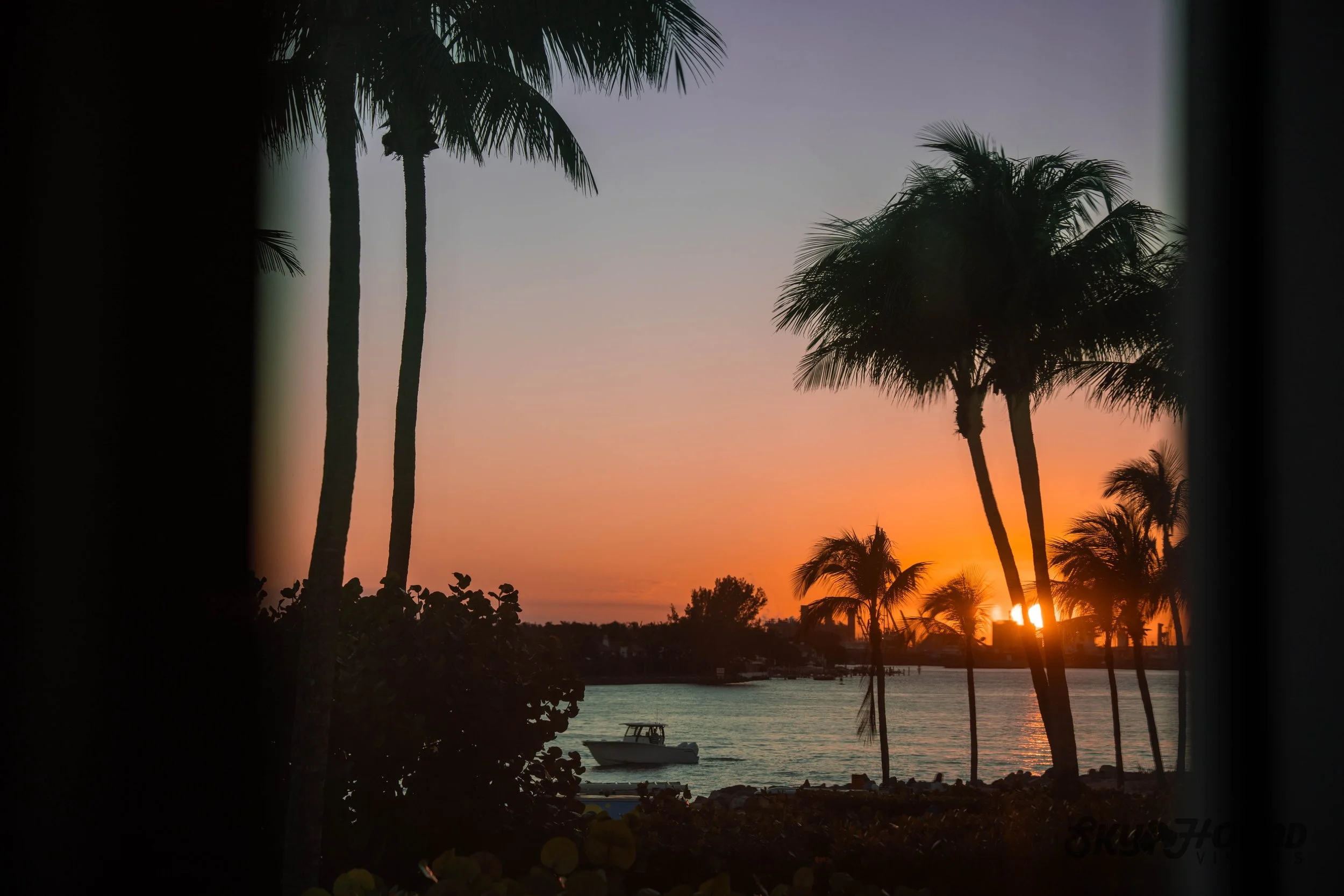 sunset image with boat in florida coast