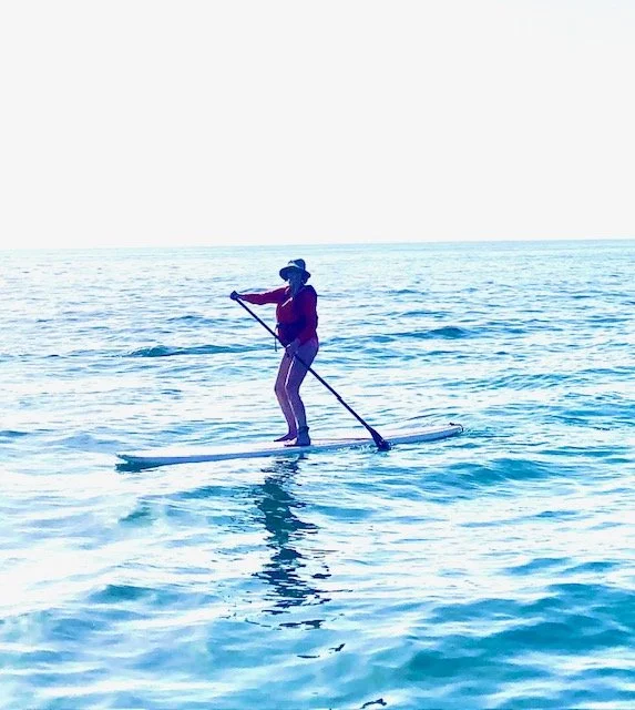 Mary paddleboarding in the ocean