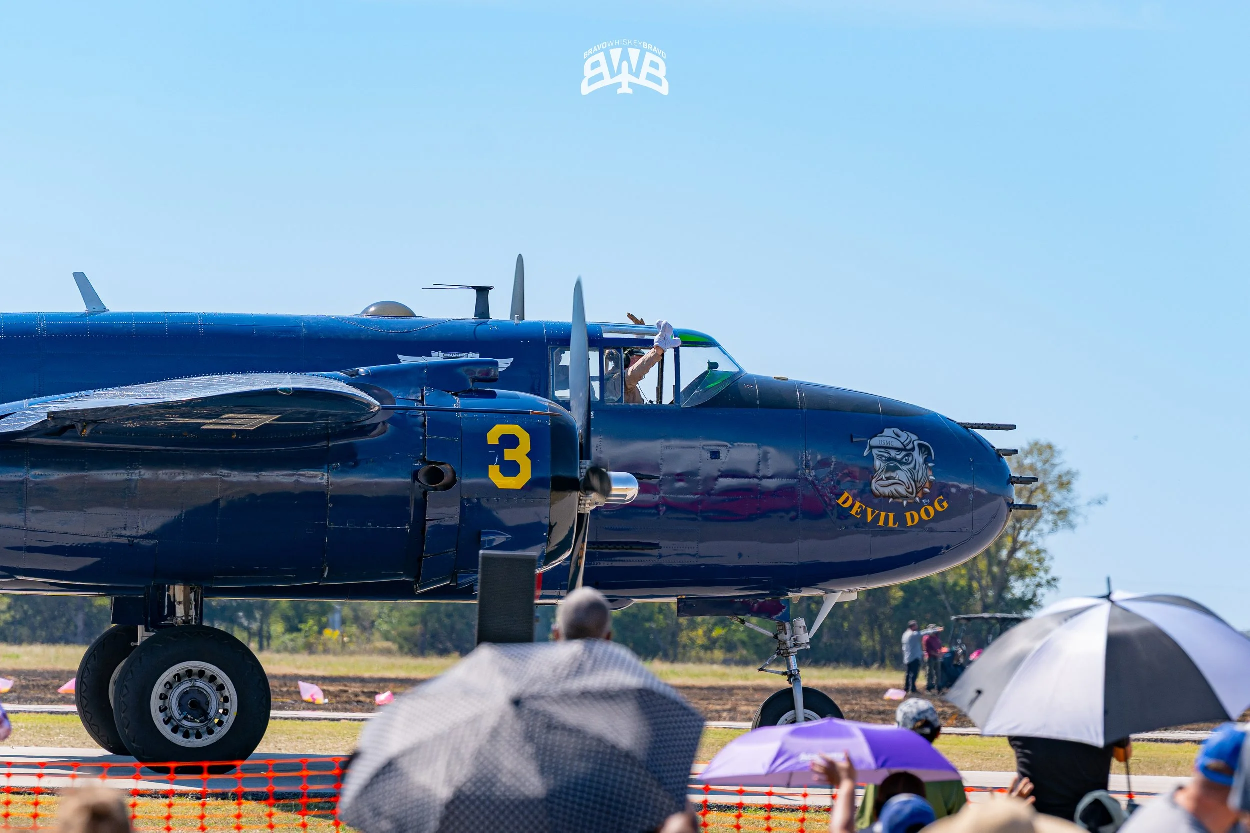 Blue military jet aircraft on display with 