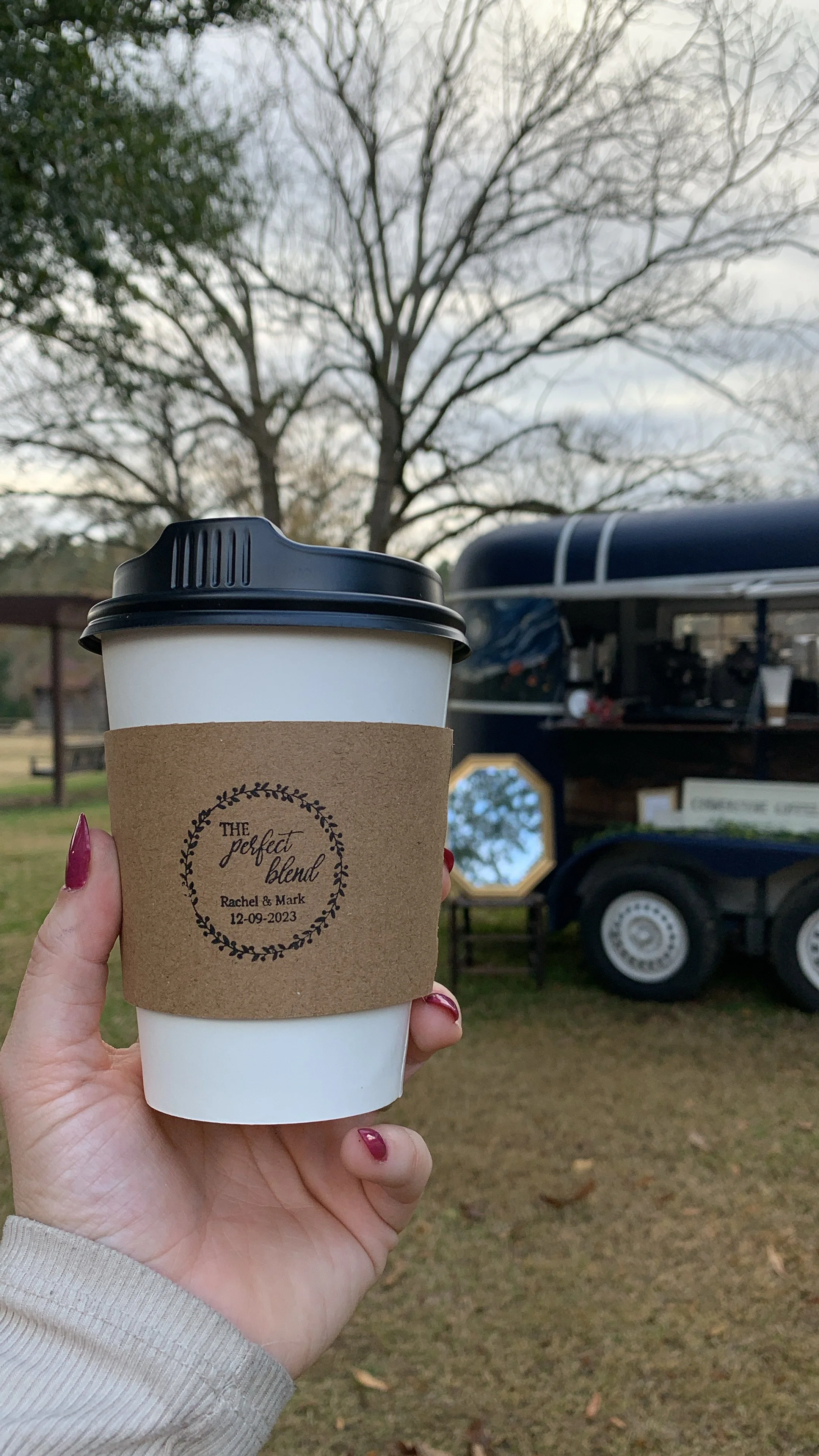 holding coffee in front of trailer.JPG