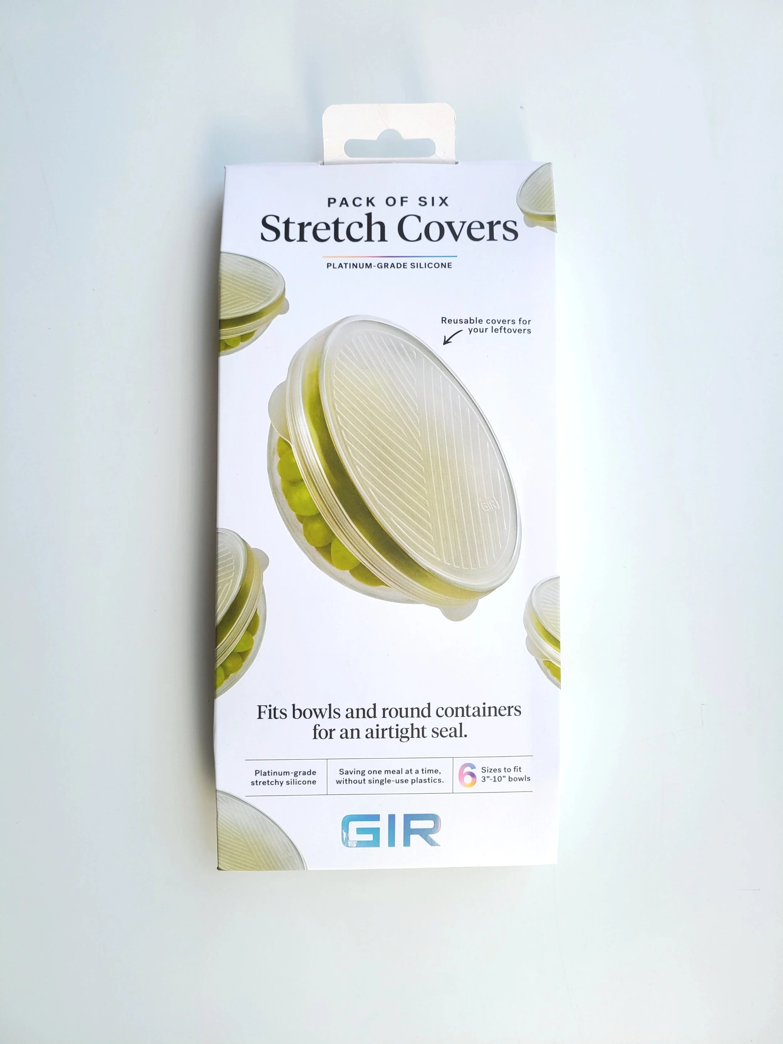 Package of six stretch covers for bowls and round containers, made of platinum-grade silicone, designed for airtight seals, fitting 3-10 inch bowls, with images of the covers on the packaging.