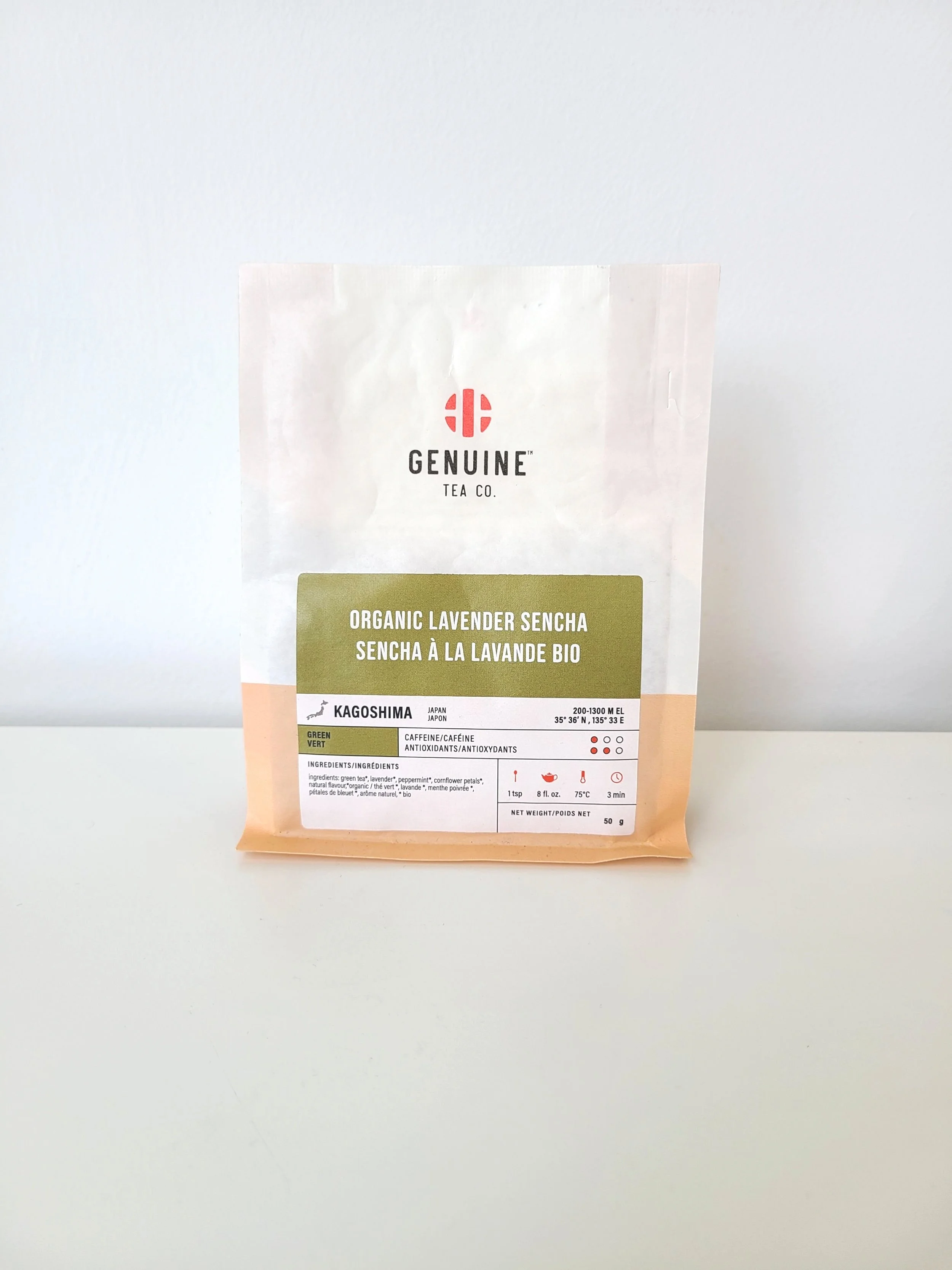 A package of Genuine Tea Co. Organic Lavender Sencha tea with green and white packaging on a white surface.